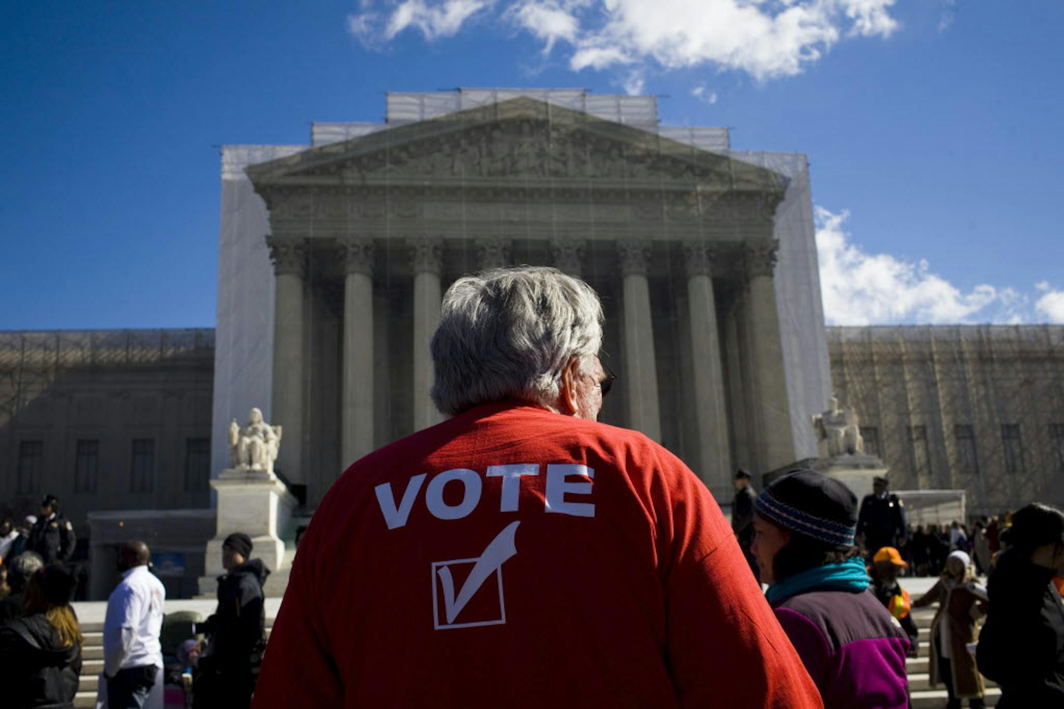 Protestors gather outside of the U.S. Supreme Court in support of Section 5 of the Voting Rights Act of 1965, in Washington, Feb. 27, 2013.