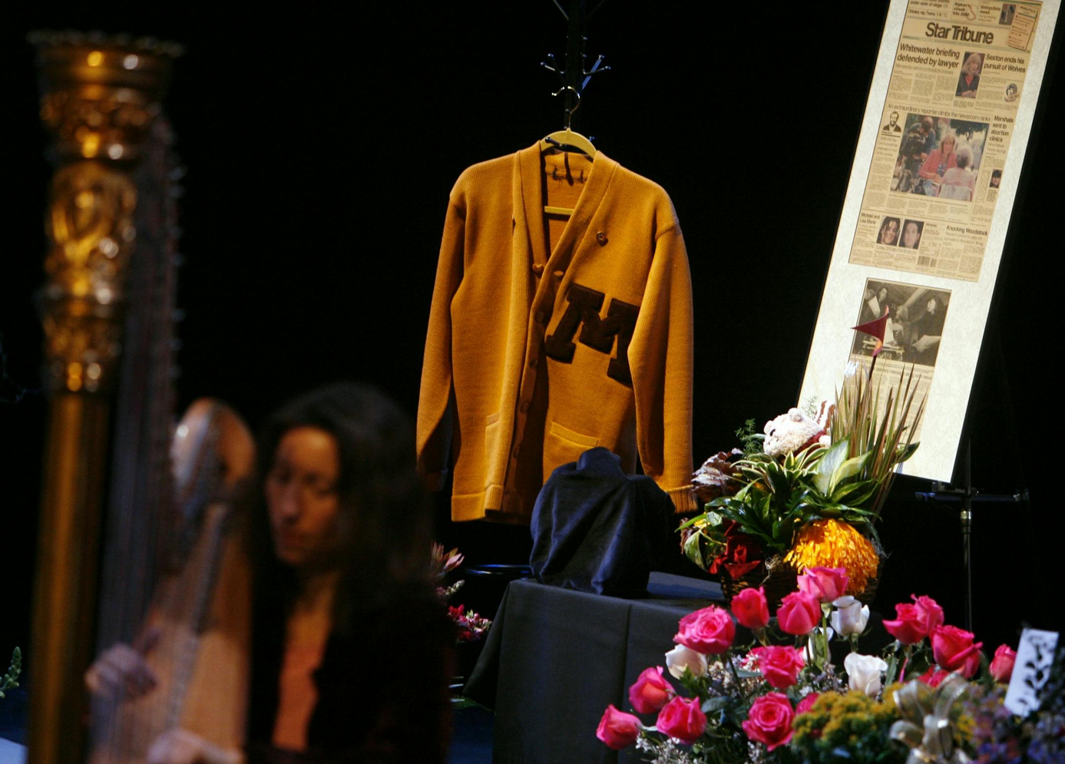 A harpist played as Pohland's University of Minnesota sweater and a newspaper clipping were displayed on stage.