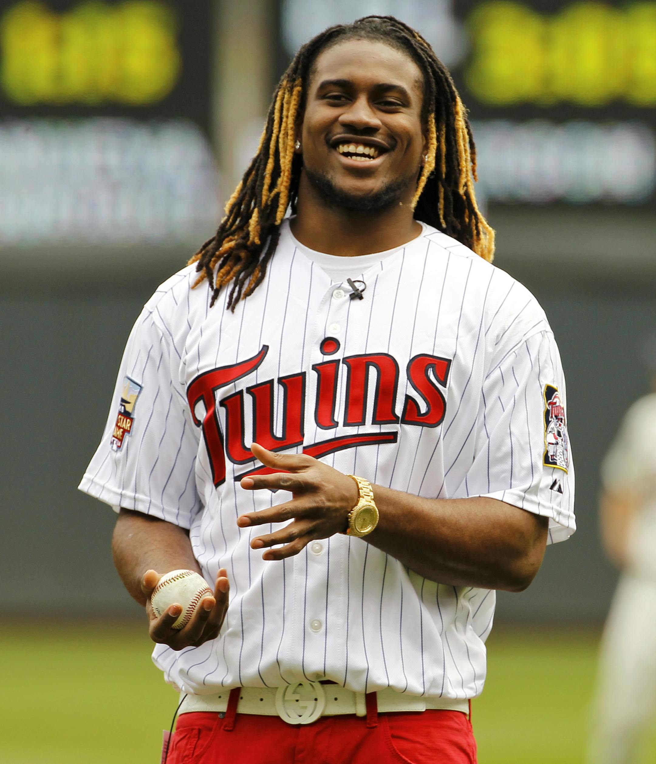 Minnesota Vikings wide receiver Cordarrelle Patterson laughs before throwing out the ceremonial pitch before a Minnesota Twins baseball game against the Kansas City Royals in Minneapolis, Saturday, April 12, 2014. (AP Photo/Ann Heisenfelt) ORG XMIT: MIN2014050218301239