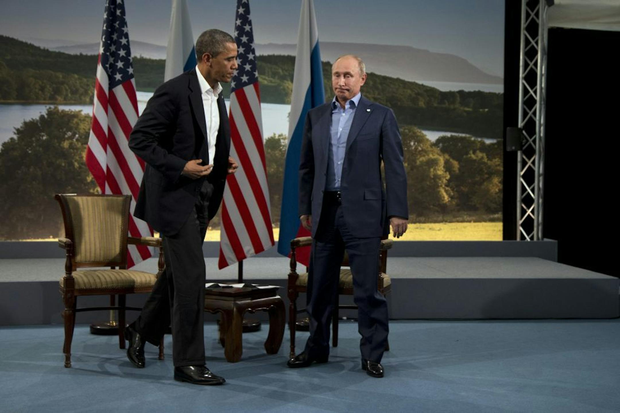 President Barack Obama and Russian President Vladimir Putin get up to leave after their meeting in Enniskillen, Northern Ireland, Monday, June 17, 2013. Obama and Putin discussed the ongoing conflict in Syria during their bilateral meeting.