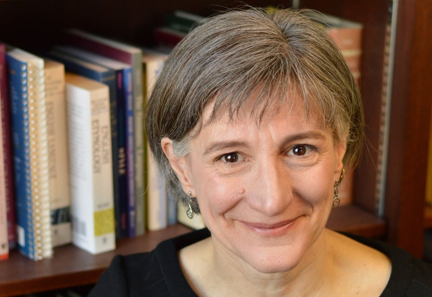 Portrait of Janet Schrunk Ericksen&nbsp;in front of bookcase.