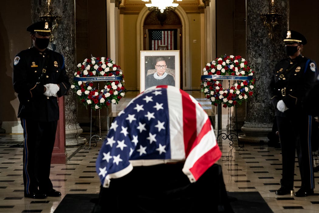 The coffin of Associate Justice Ruth Bader Ginsburg as she lies in state at Statuary Hall of the Capitol in Washington, Sept. 25, 2020. The lifetime tenure granted to Supreme Court justices means that laws affecting hundreds of millions of people can hang on the happenstance of a single elderly citizen’s decline. 