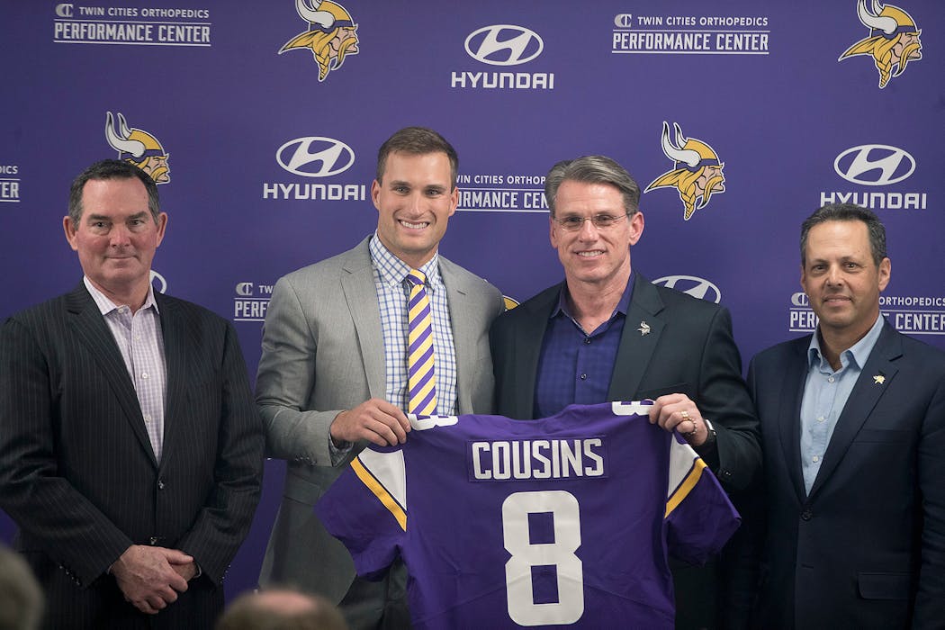 Vikings coach Mike Zimmer, quarterback Kirk Cousins, GM Rick Spielman and co-owner Mark Wilf after Cousins signed with the team in March 2018.