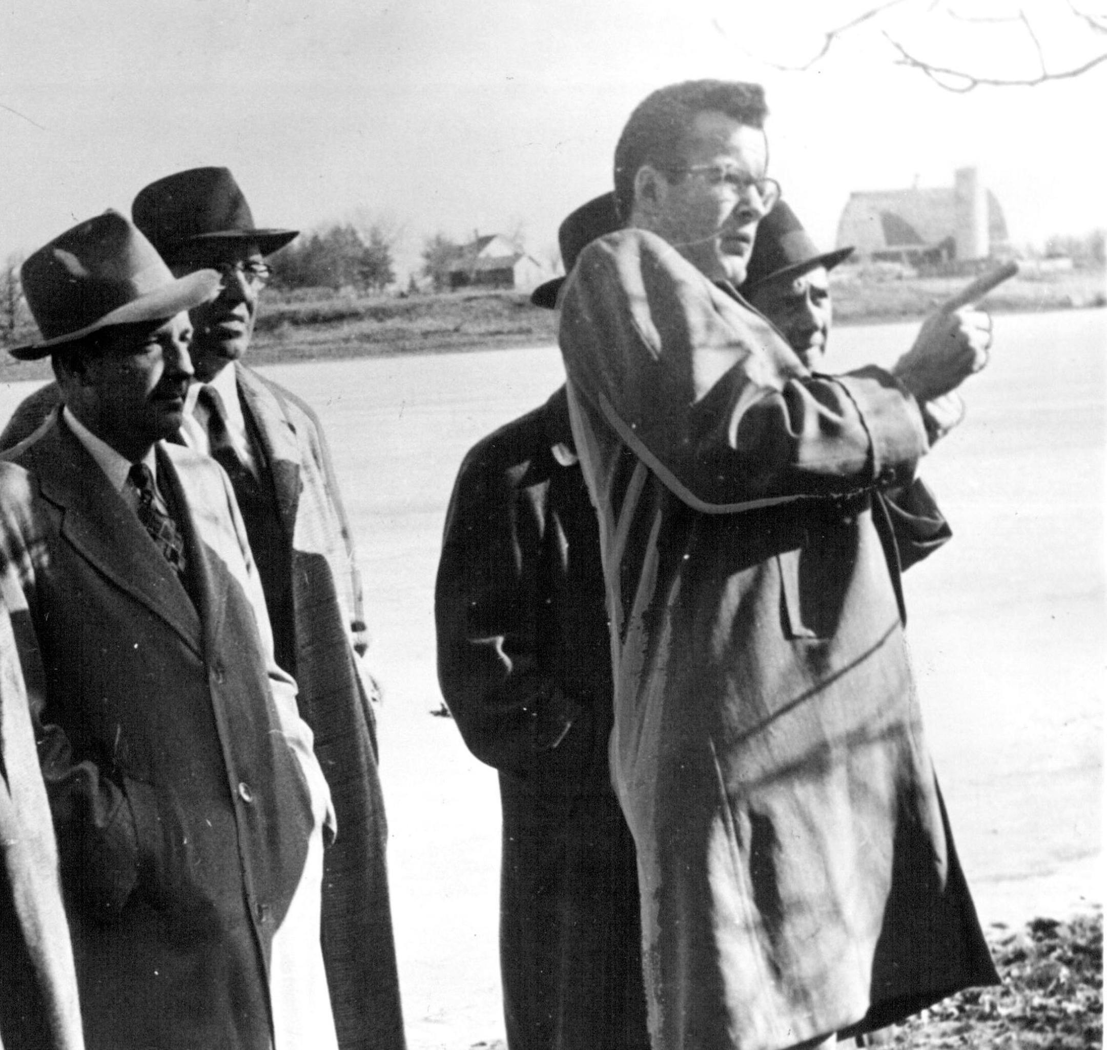 James Peter Taylor, escorted by federal authorities after he was captured, pointed to the location where he said he killed Thief River Falls, Minn., banker Kenneth Lindberg in 1955.