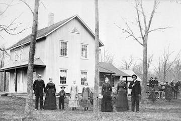 Andrew and Elsa Peterson and their nine children in front of their farmhouse near Waconia, likely in the 1890s.