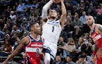 Minnesota Timberwolves' Tyus Jones (1) attempts a shot while being defended by Washington Wizards' Tim Frazier (8) in the first quarter on Tuesday, No