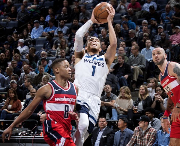 Minnesota Timberwolves' Tyus Jones (1) attempts a shot while being defended by Washington Wizards' Tim Frazier (8) in the first quarter on Tuesday, No