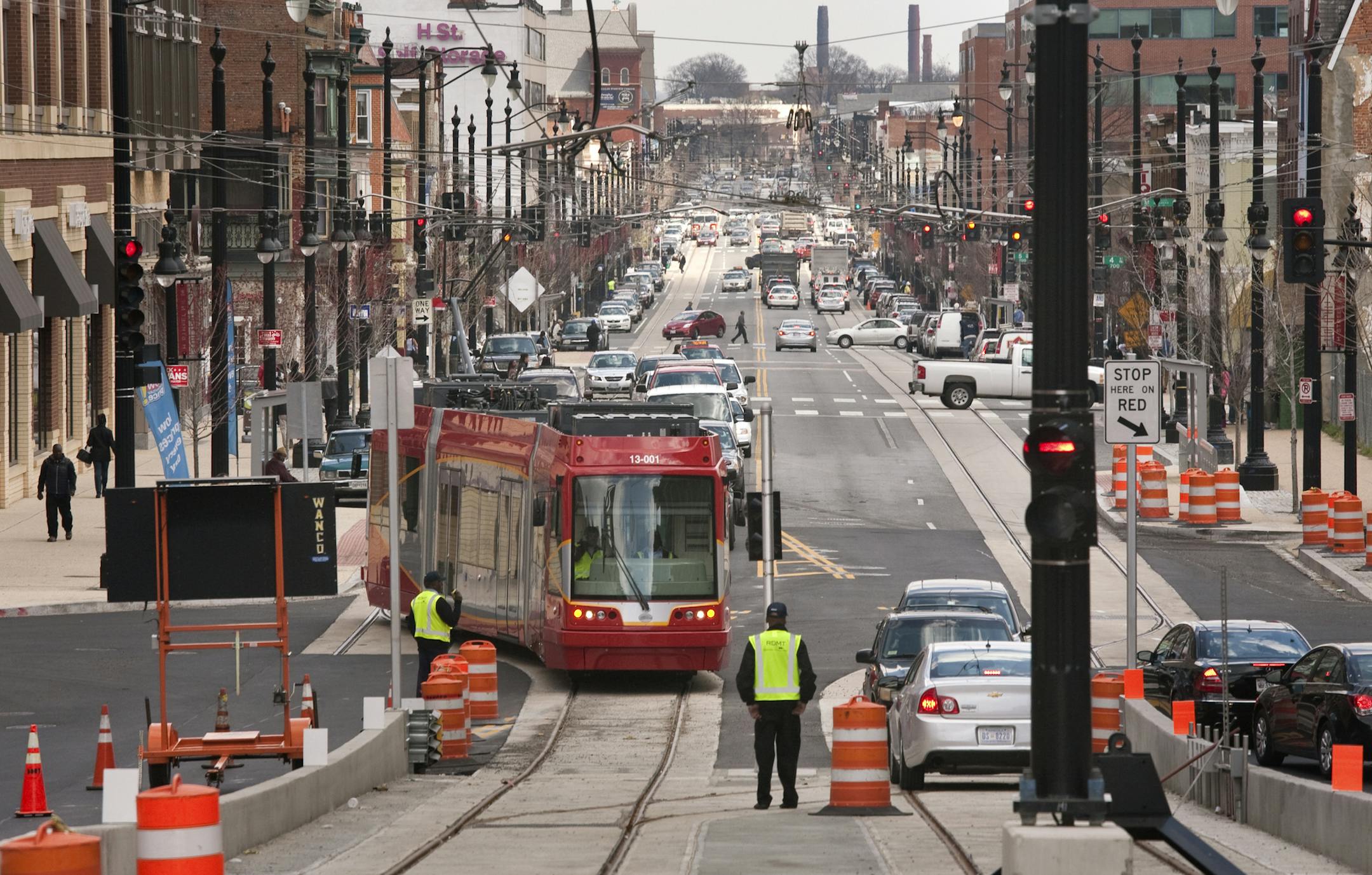 FILE-- Workers test new streetcars which will run along the H Street NE shopping district in Washington, April 9, 2014. The District council, worried about escalating costs, cut the planned system in half that year. While several cities inaugurate new systems or expand older ones, the streetcar revolution, faced with fiscal and operational challenges, has stalled elsewhere. (Daniel Rosenbaum/The New York Times)
