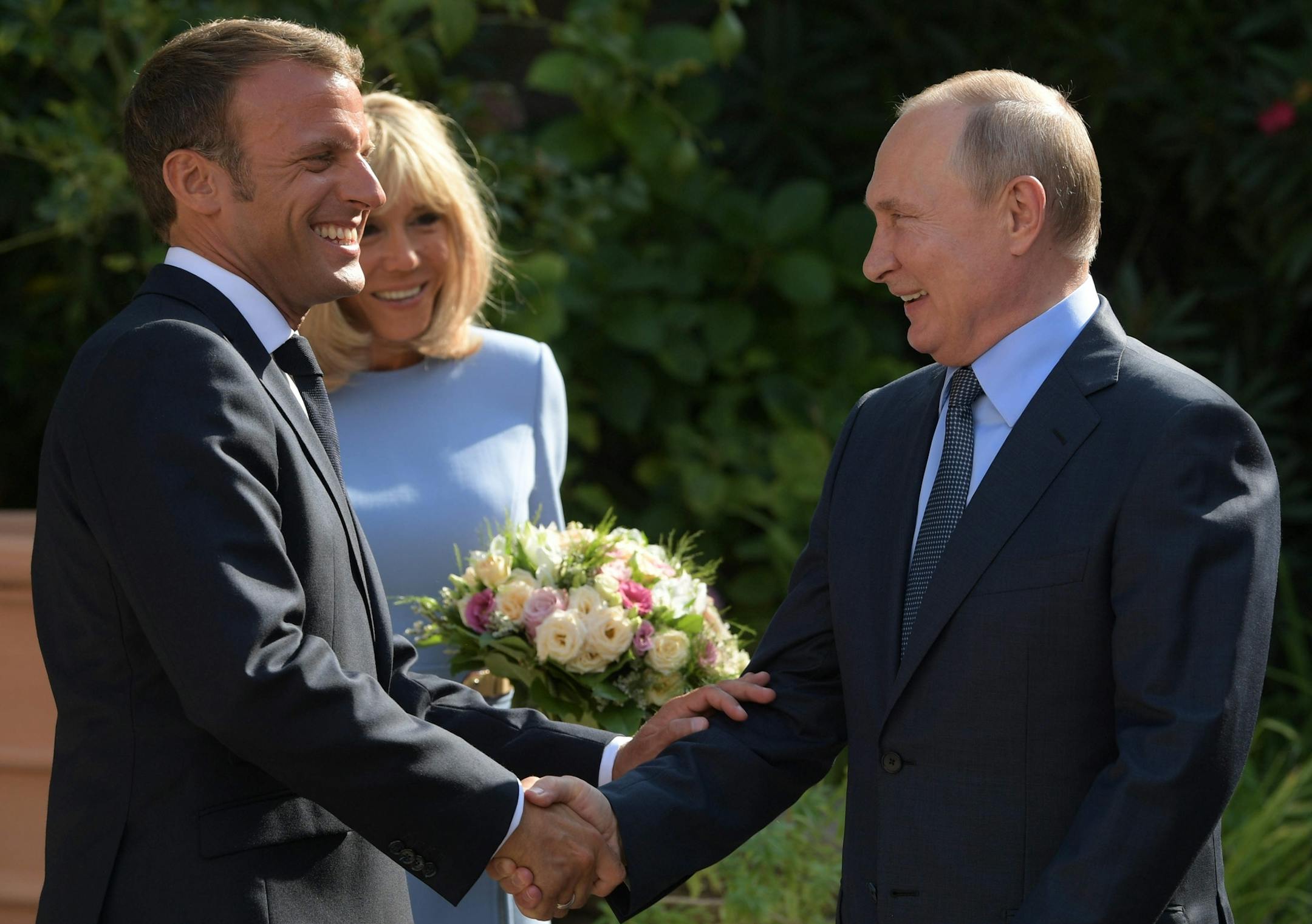 French President Emmanuel Macron, left, his wife Brigitte, welcome Russian President Vladimir Putin at the fort of Bregancon in Bormes-les-Mimosas, southern France, Monday Aug. 19, 2019. French President Emmanuel Macron and Russian President Vladimir Putin are meeting to discuss the world's major crises, including Ukraine, Iran and Syria, and try to improve Moscow's relations with the European Union. (Alexei Druzhinin, Sputnik, Kremlin Pool Photo via AP)