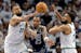 P.J. Washington (25) of the Mavericks is defended by Rudy Gobert (27) and Karl Anthony Towns of the Wolves on Wednesday night at Target Center.