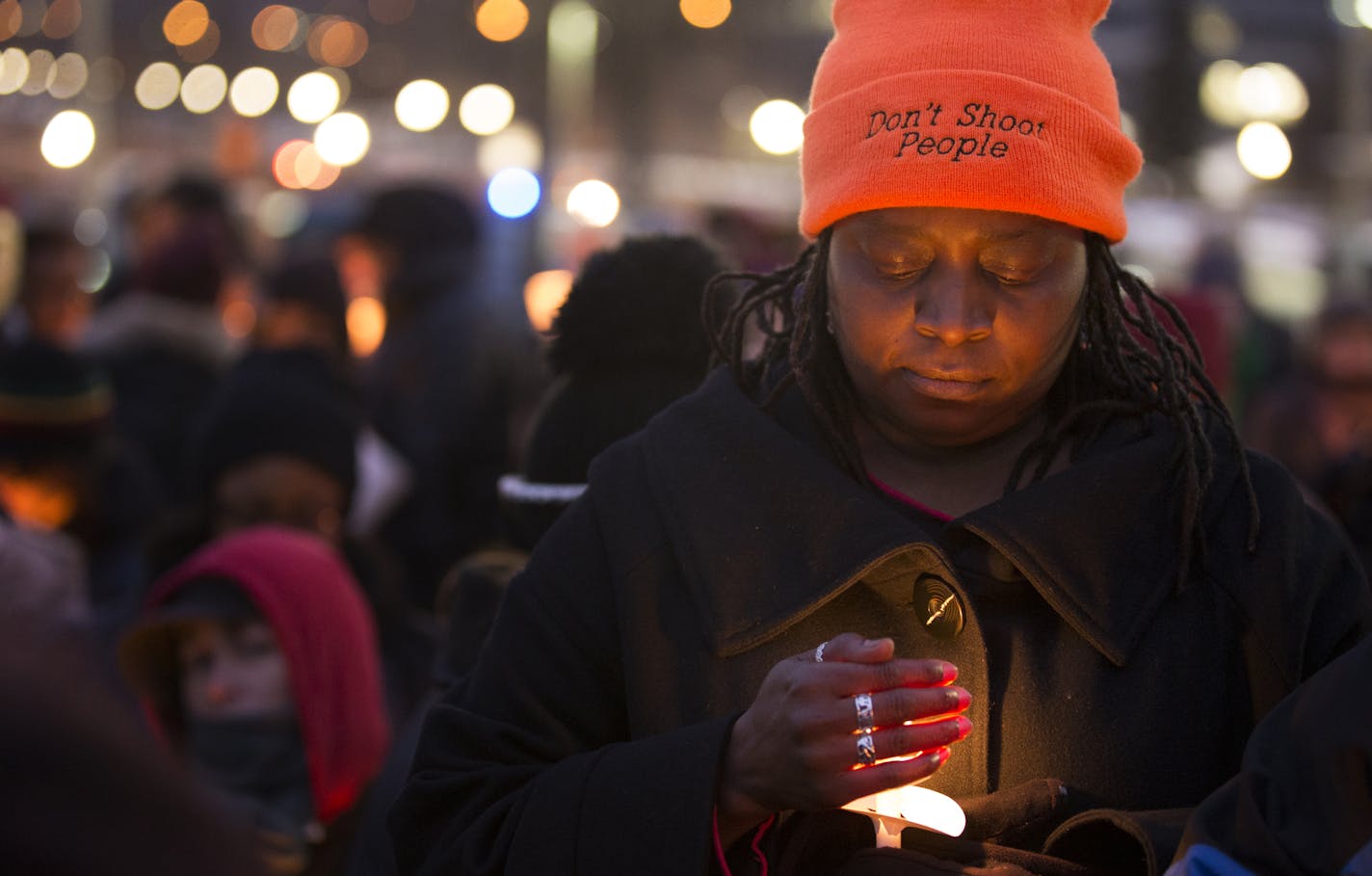 A woman stands on the Capitol steps during a vigil for Marcus Golden during the ReclaimMLK march in St. Paul on Monday, January 19, 2015. ] LEILA NAVIDI leila.navidi@startribune.com /