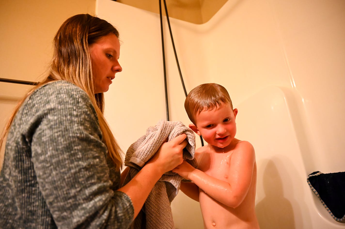 Heather Hedin and children Katelyn, 6, and Jackson, 3, are managing while Capt. Rich Hedin has been in Iraq and Kuwait with the Minnesota National Guard. She gave Jackson a bath after dinner Tuesday night.