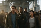 This image released by Twentieth Century Fox shows, foreground from left, Dylan O'Brien, Giancarlo Esposito and Rosa Salazar in a scene from "Maze Run