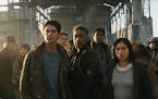 This image released by Twentieth Century Fox shows, foreground from left, Dylan O'Brien, Giancarlo Esposito and Rosa Salazar in a scene from "Maze Run