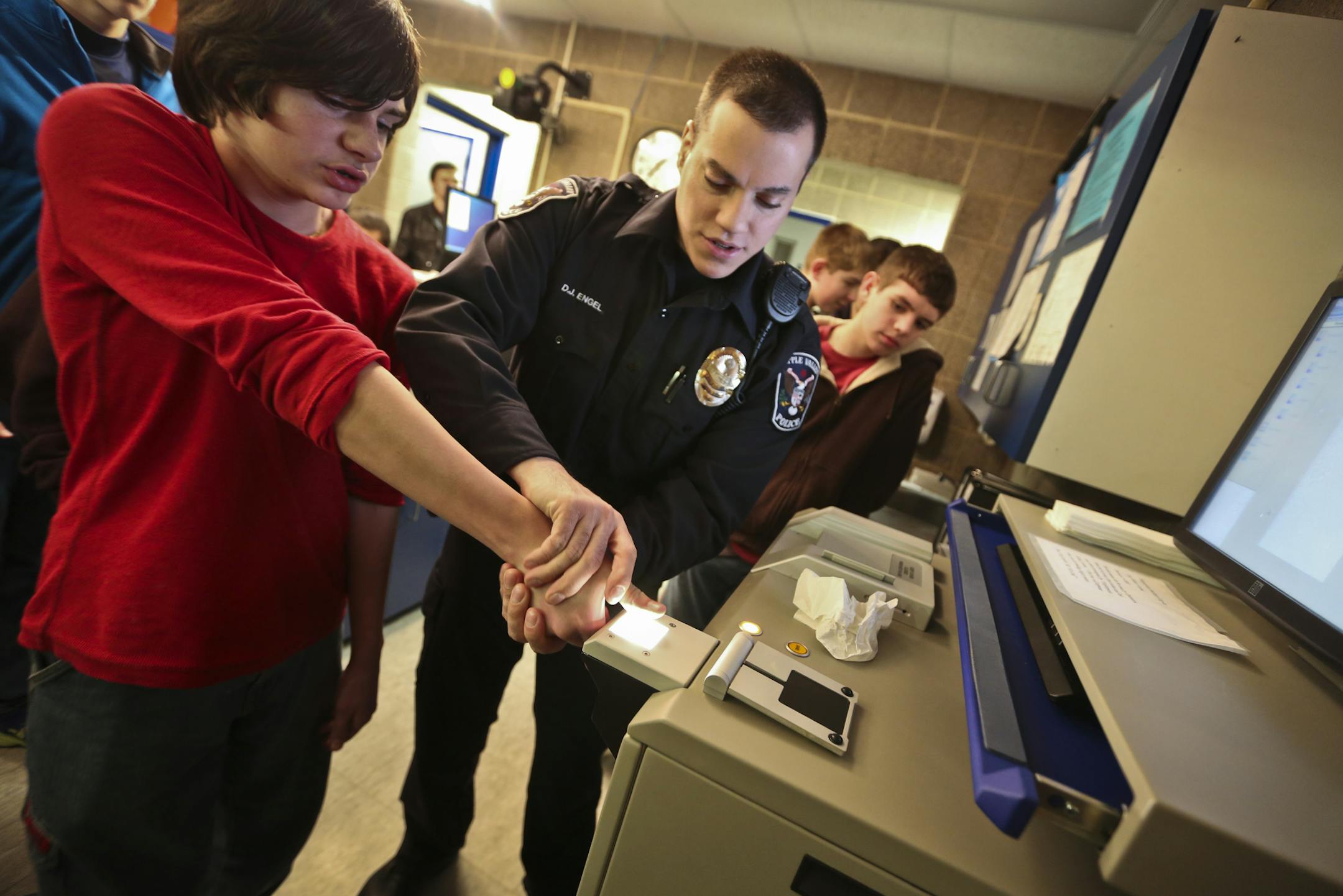 This won’t hurt a bit: David Engel fingerprinted Matt Morgan, 14, during a Teen Police Academy tour of the booking area of Apple Valley’s police headquarters.