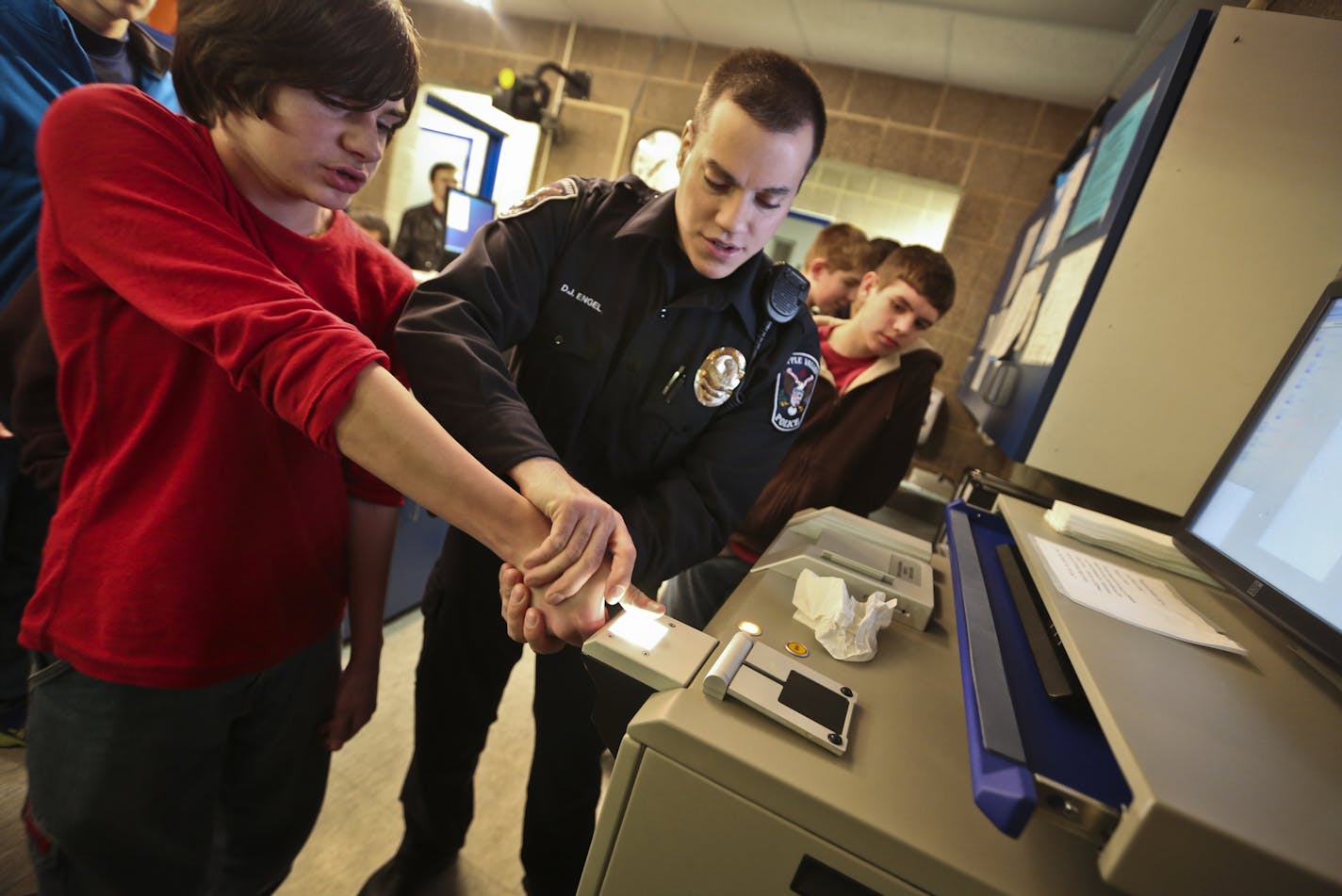 This won&#x2019;t hurt a bit: David Engel fingerprinted Matt Morgan, 14, during a Teen Police Academy tour of the booking area of Apple Valley&#x2019;s police headquarters.