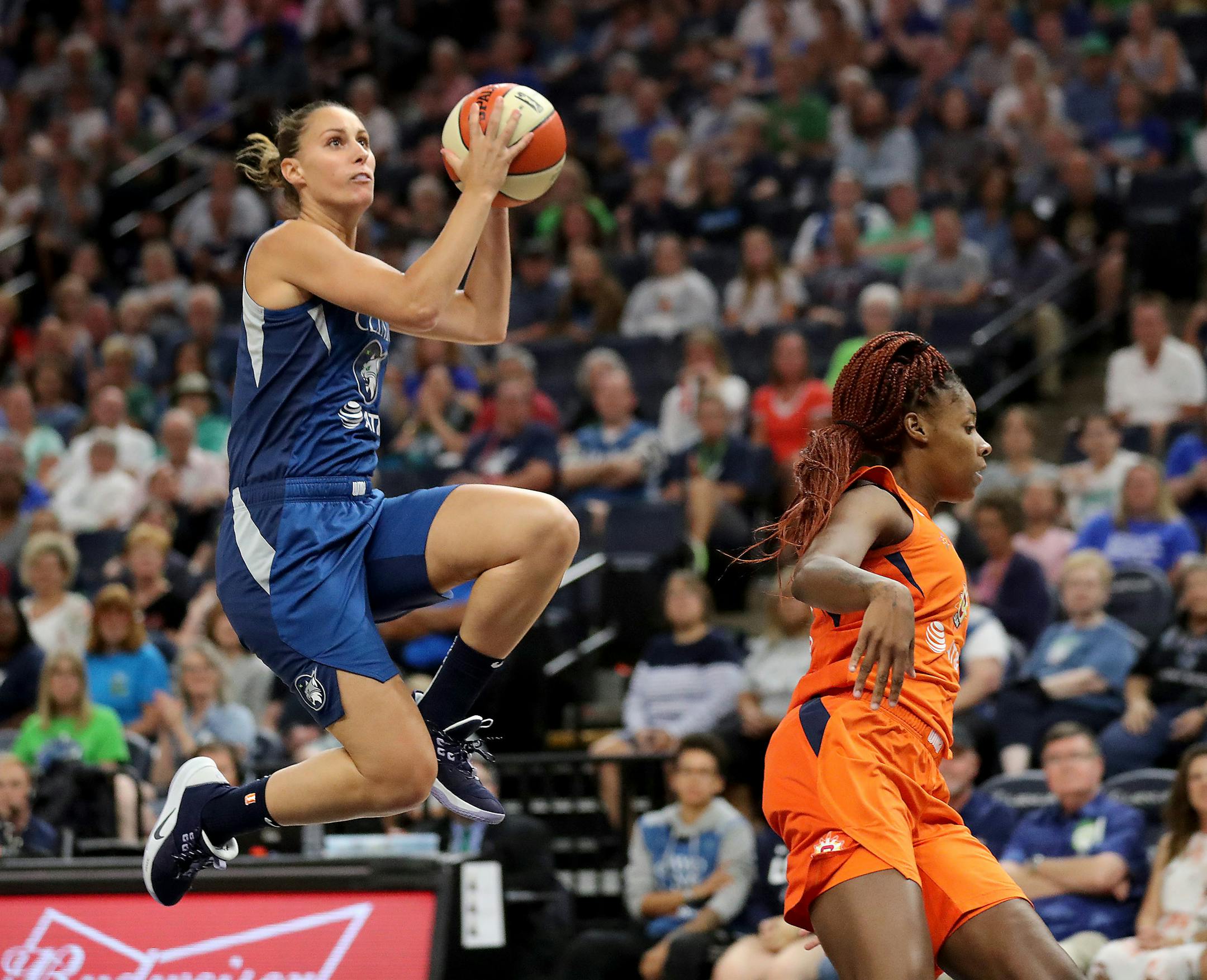 The Lynx's Stephanie Talbot puts a move on the Sun's Bria Holmes on her way to a fast break basket during the first quarter