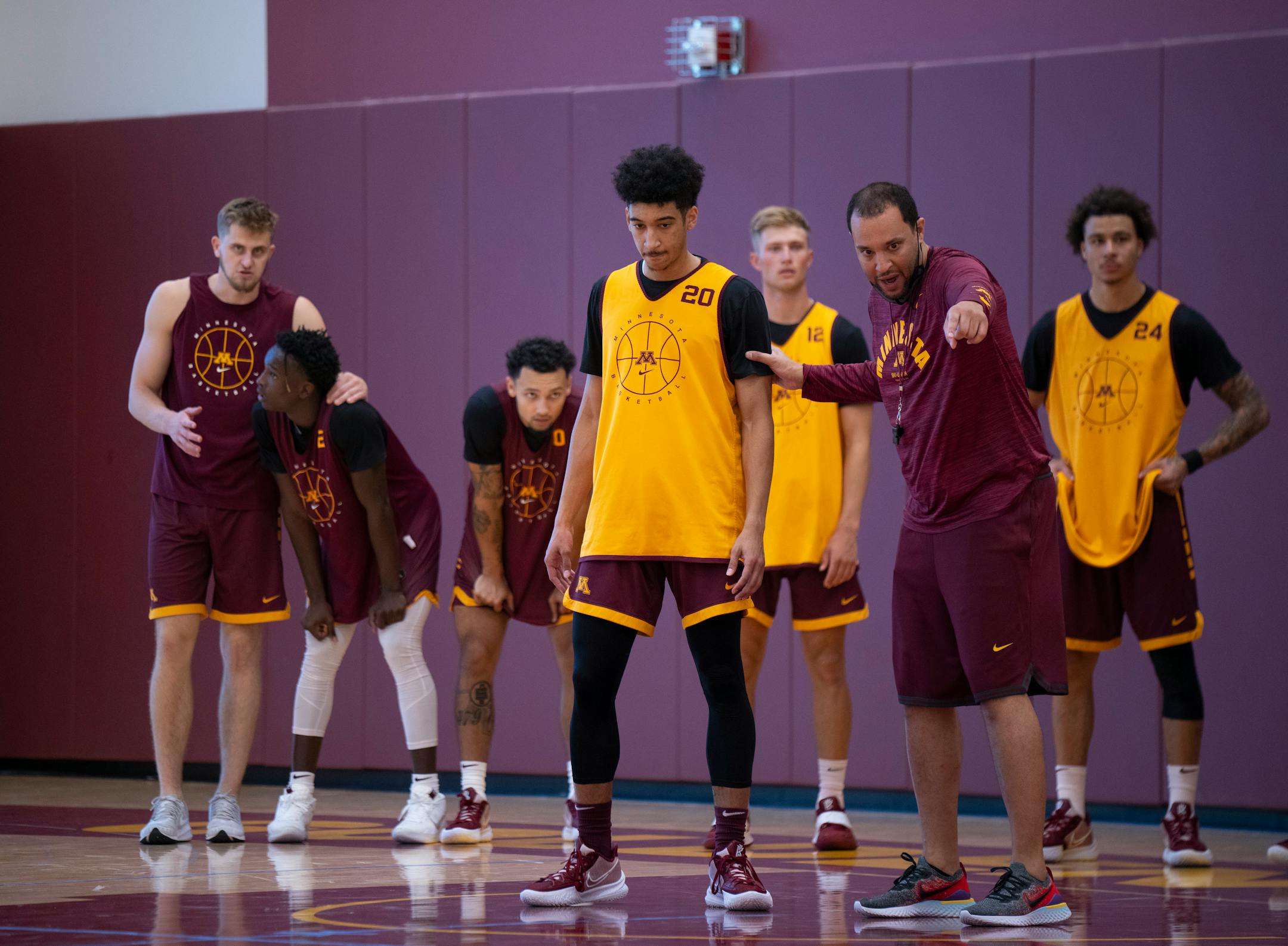 Head coach Ben Johnson explained a drill to guard Eylijah Stephens (20) at the team's first practice Tuesday afternoon.