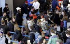 FILE - In this Sunday, Nov. 29, 2015, file photo, travelers line up at a security checkpoint area in Terminal 3 at O'Hare International Airport in Chi