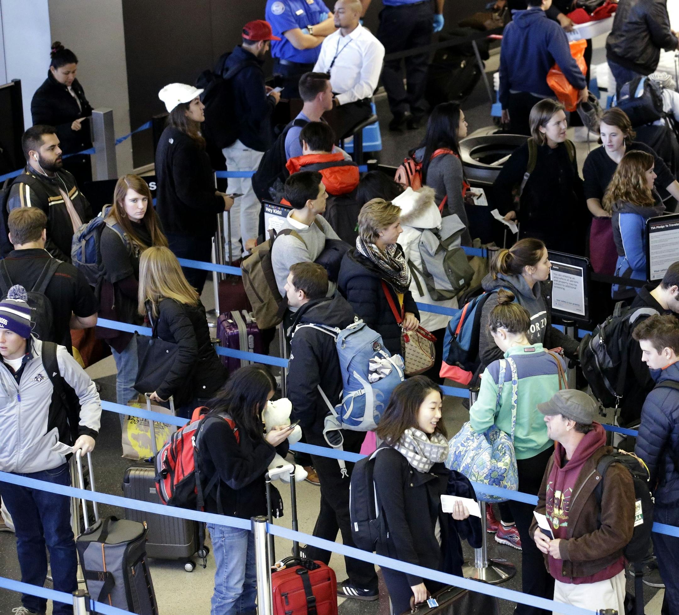 FILE - In this Sunday, Nov. 29, 2015, file photo, travelers line up at a security checkpoint area in Terminal 3 at O'Hare International Airport in Chicago. The auto club AAA said Tuesday, Nov. 15, 2016, that it expects 1 million more Americans to venture at least 50 miles from home, a 1.9 percent increase over last year. (AP Photo/Nam Y. Huh, File)