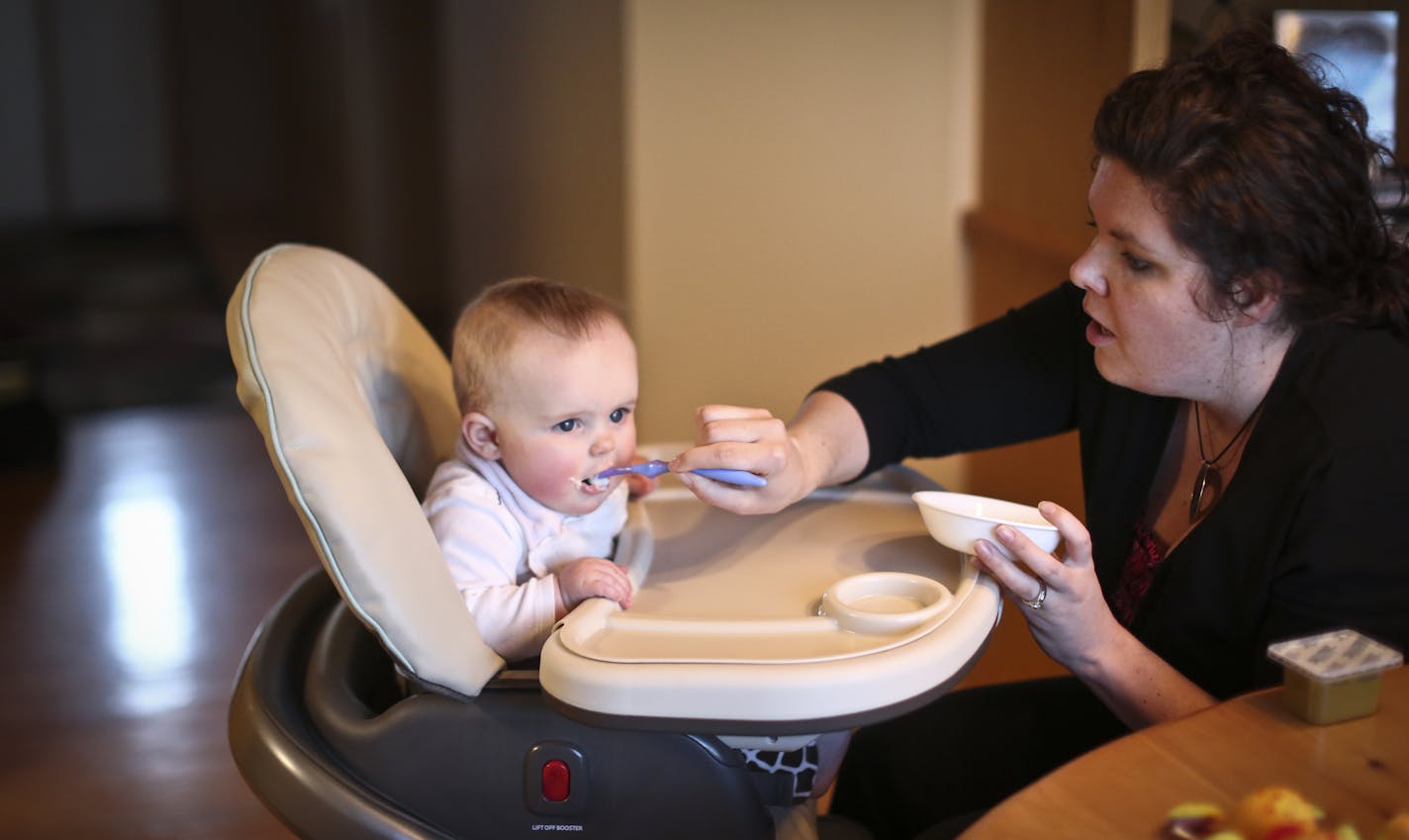 Andrea Pedersen fed her daughter Anna at home on Thursday, March 7, 2013, in Rochester, Minn. Last year, when she was pregnant, Andrea Pedersen was invited to take part in an experiment at the Mayo Clinic, where she works. She took home a fetal monitor to listen to the baby's heartbeat at home, and did one prenatal visit by Skype. ] (RENEE JONES SCHNEIDER * reneejones@startribune.com)