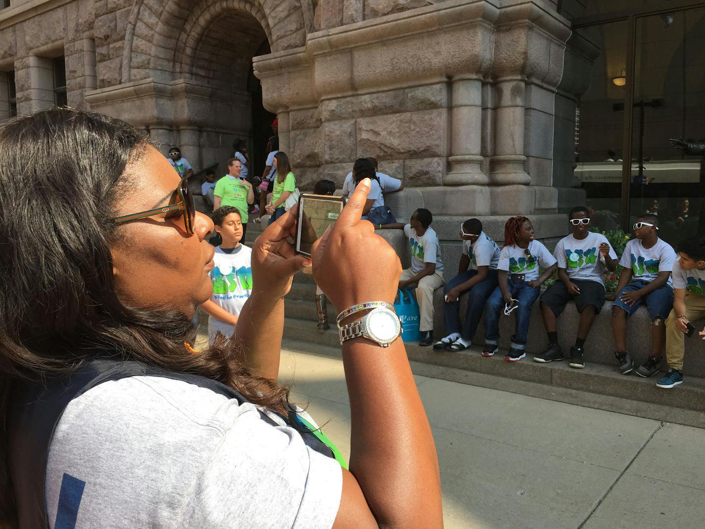 Latrisha Vetaw, from the Northpoint Health and Wellness Center's Breathe Free North program, takes a photo of young people who turned out in support of the Minneapolis City Council vote to ban flavored tobacco products.