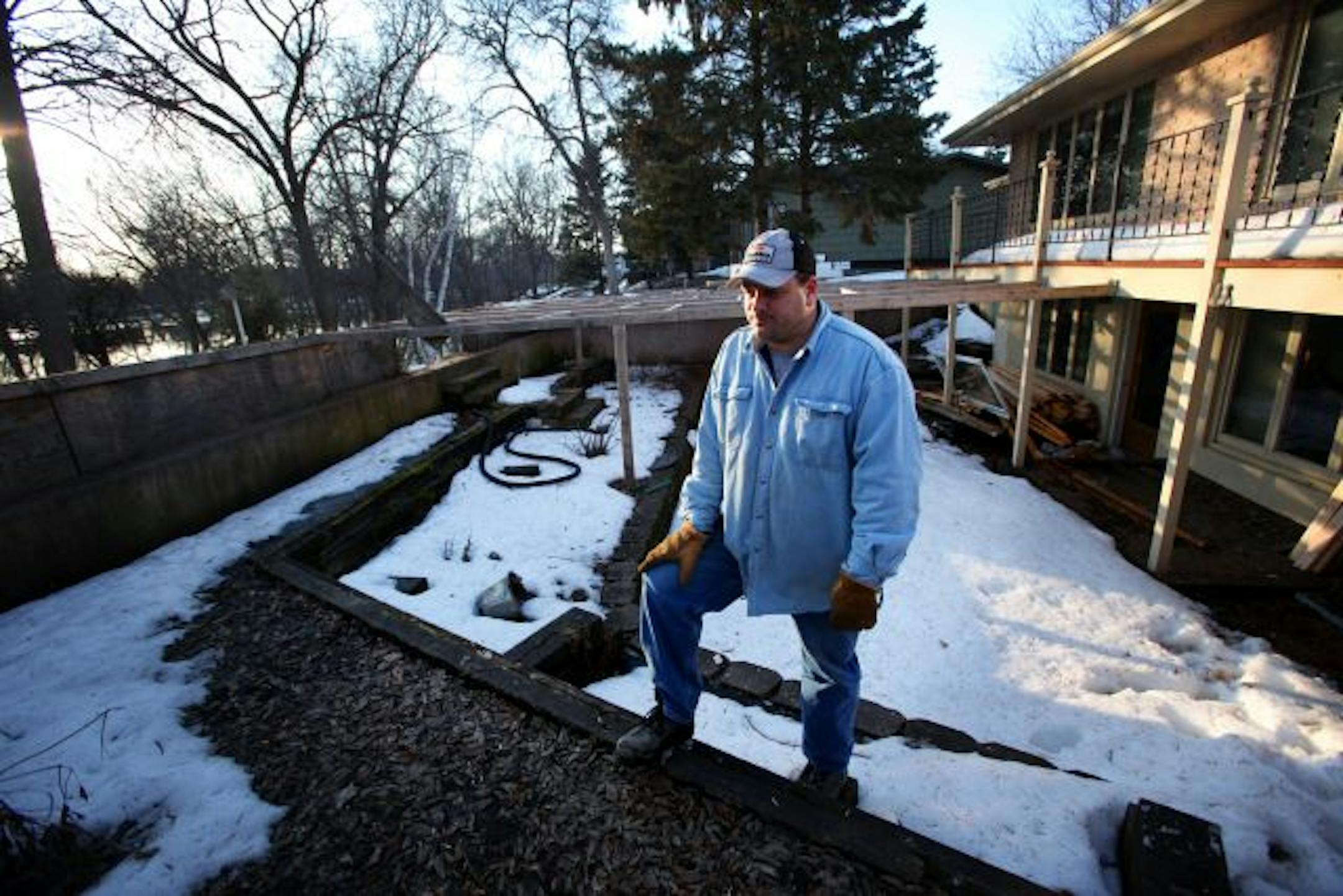 Brad Thom stood in the backyard of the house he sold this year through a buyout program for homes along the Red River in danger of flooding. The home had a dike built in to the back by the former owner that was still not high enough for the 2009 flood. Brad and his wife were back in the neighborhood to help their old neighbors sandbag their homes.