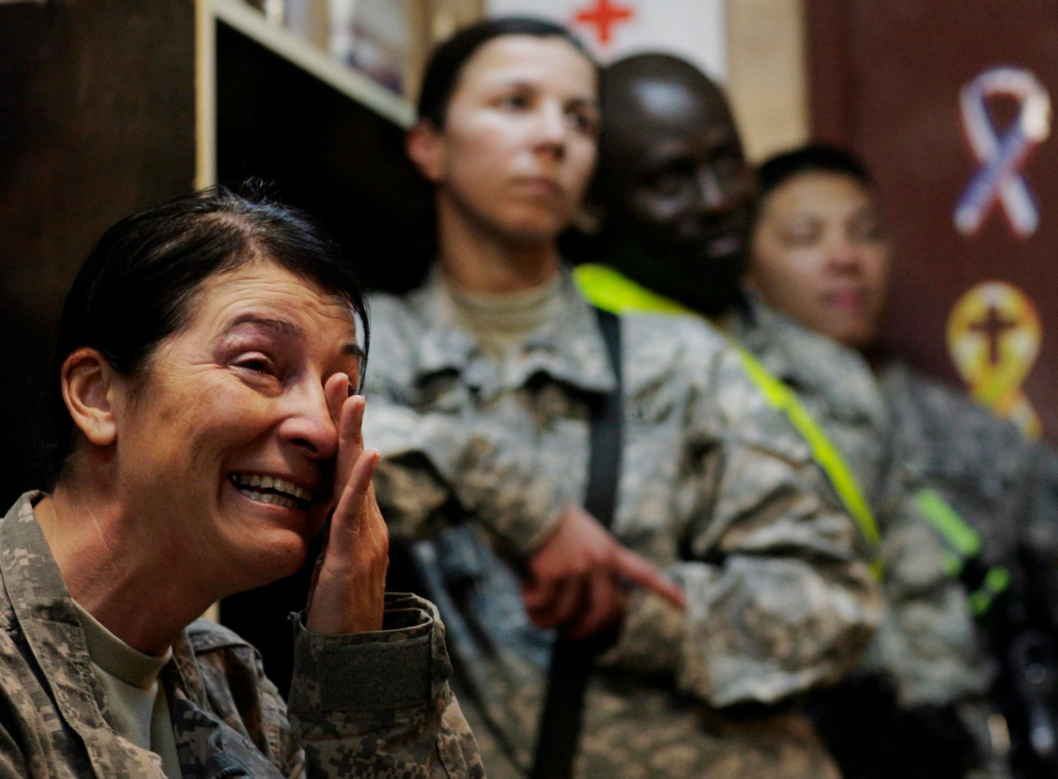 US Army Command Sgt. Maj. Julia Kelley, left, of the 229th Brigade Support Battalion, 2nd Heavy Brigade Combat Team, 1st Infantry Division, weeps as she watches the inauguration of US President Barack Obama at Camp Liberty in Baghdad, Iraq, Tuesday, Jan. 20, 2009. "We have a new commander in chief," exclaimed Command Sgt. Maj. Julia Kelley, 47, of Billings, Montana. "It was an awesome feeling, due to the change. And it's always a change when we get a new commander in chief." Across Iraq, many of