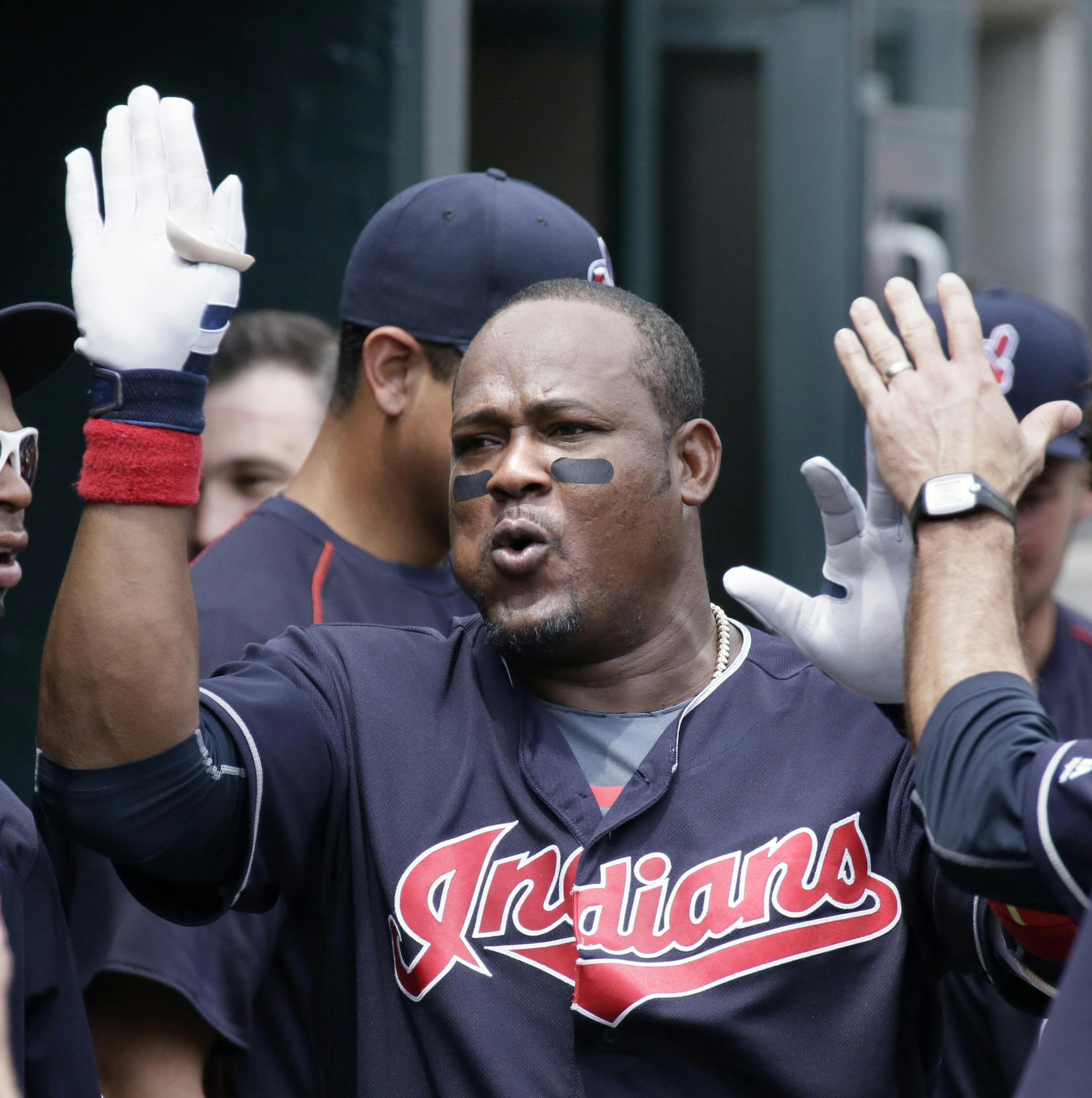 Cleveland Indians' Juan Uribe celebrates in the dugout after hitting a solo home run against the Detroit Tigers during the fifth inning of a baseball game Sunday, June 26, 2016, in Detroit. (AP Photo/Duane Burleson)