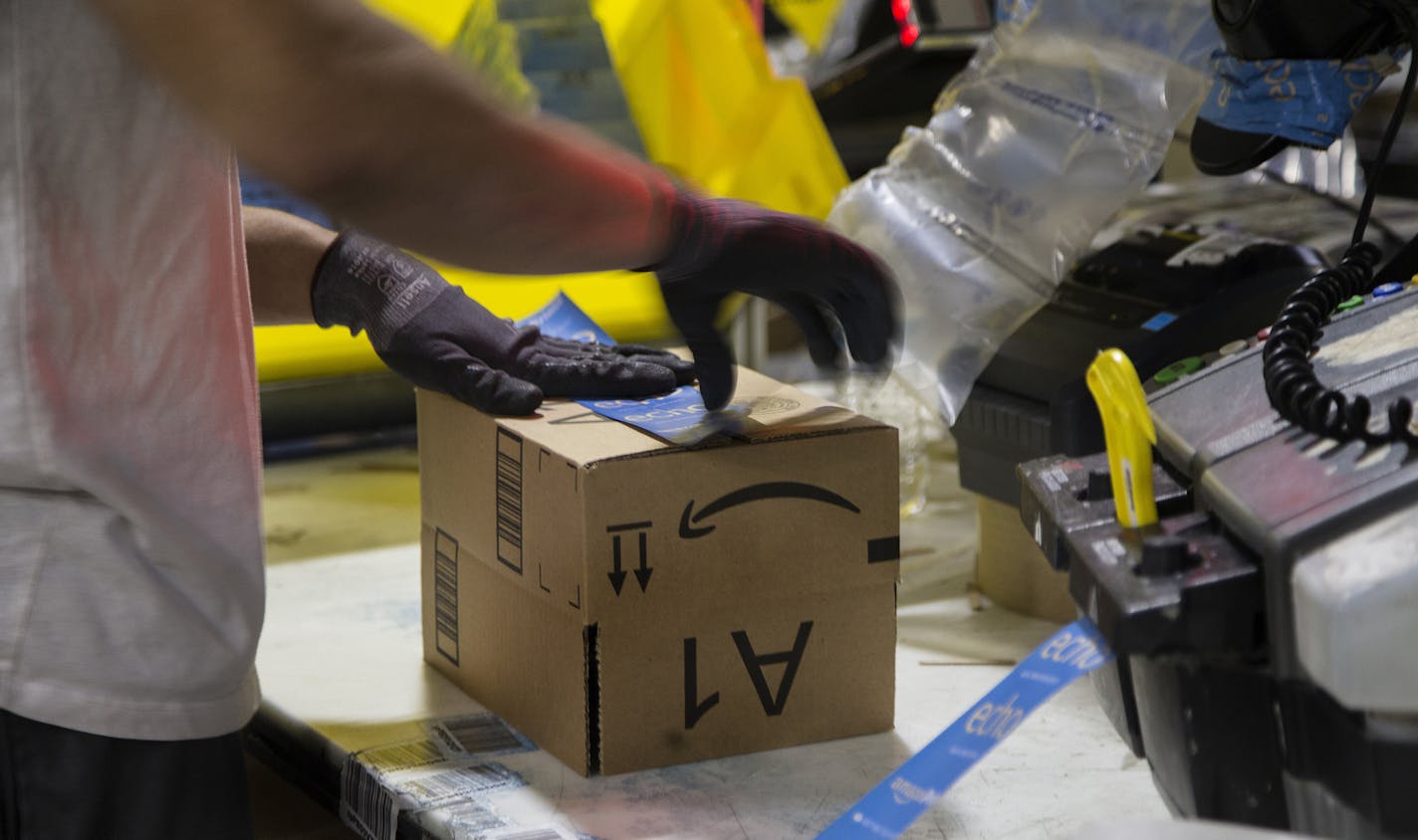 A worker tapes a box while packing items on Cyber Monday at the Amazon Fulfillment Center on Nov. 28, 2016 in San Bernardino, Calif.