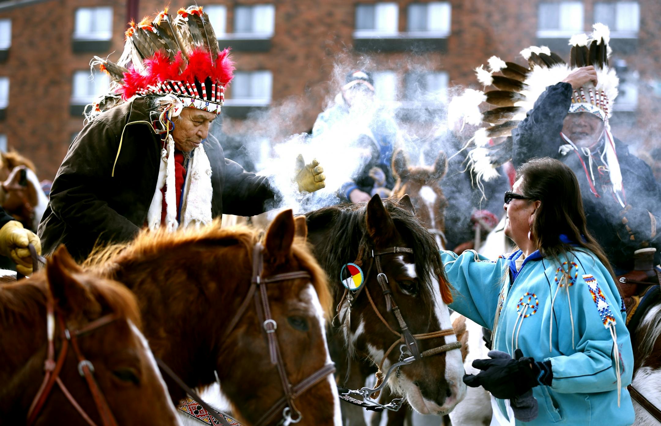A rider received sage smoke from Corbie of Crow Creek, South Dakota, after arriving at Reconciliation Park for the Dakota Wokiksuye Memorial Ride Thursday December 26, 2013 in Mankato ,MN. Dakota Native Americans ride horses from South Dakota 330 miles to Mankato to commemorate the 1862 hanging of 38 braves in Mankato -- the largest mass execution in US History. After the riders come in at 10, they will burn sage, dance and pray and give speeches.