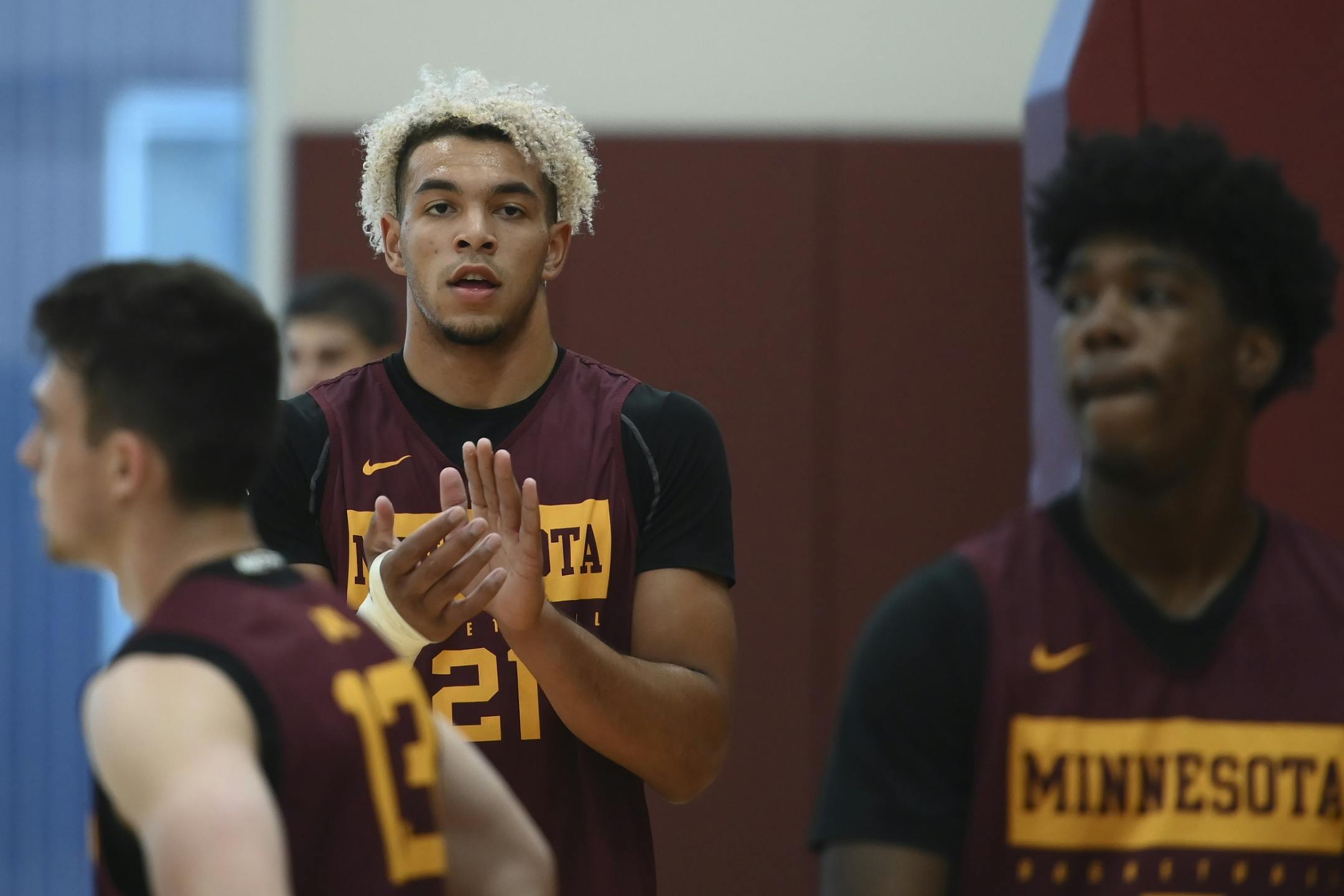 Gophers forward Jarvis Omersa (21) clapped during Tuesday's practice.