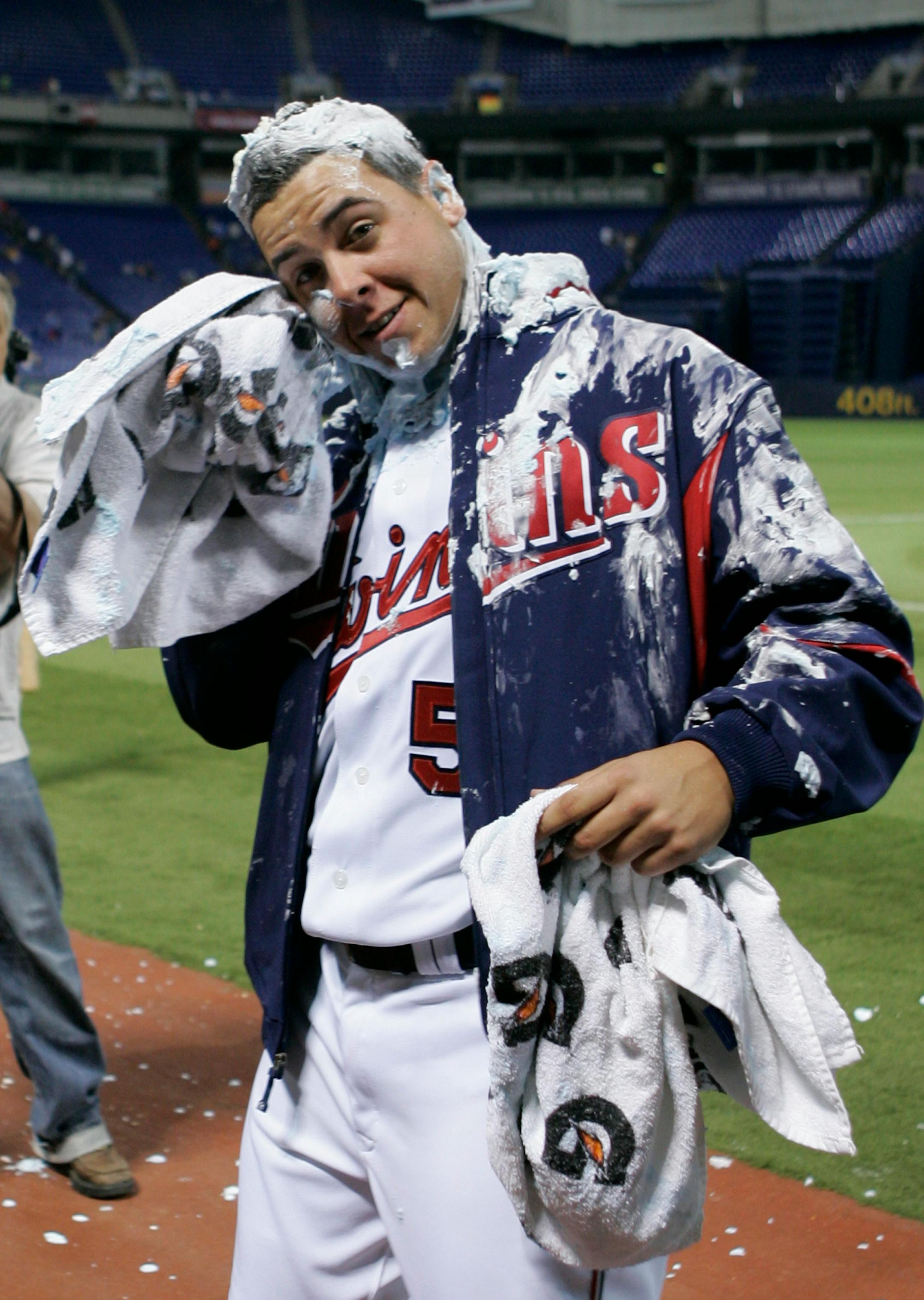 Minnesota Twins pitcher Anthony Swarzak wipes off shaving cream teammates hit him with during an interview after winning his Major League debut as the Twins defeated the Milwaukee Brewers 6-1 in a baseball game Saturday, May 23, 2009, in Minneapolis. (AP Photo/Jim Mone)