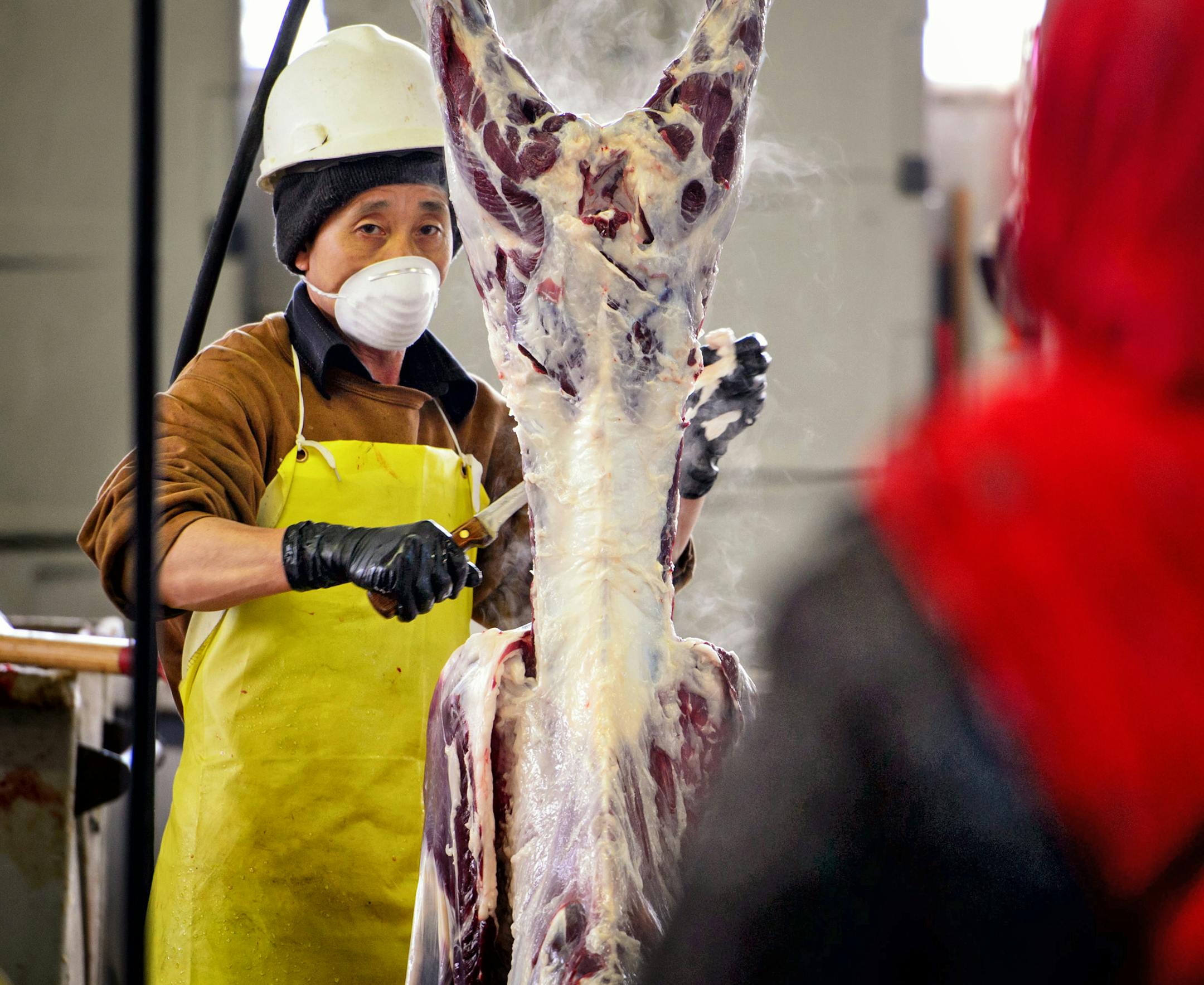 The Somali customers watched as the goat was butchered.
