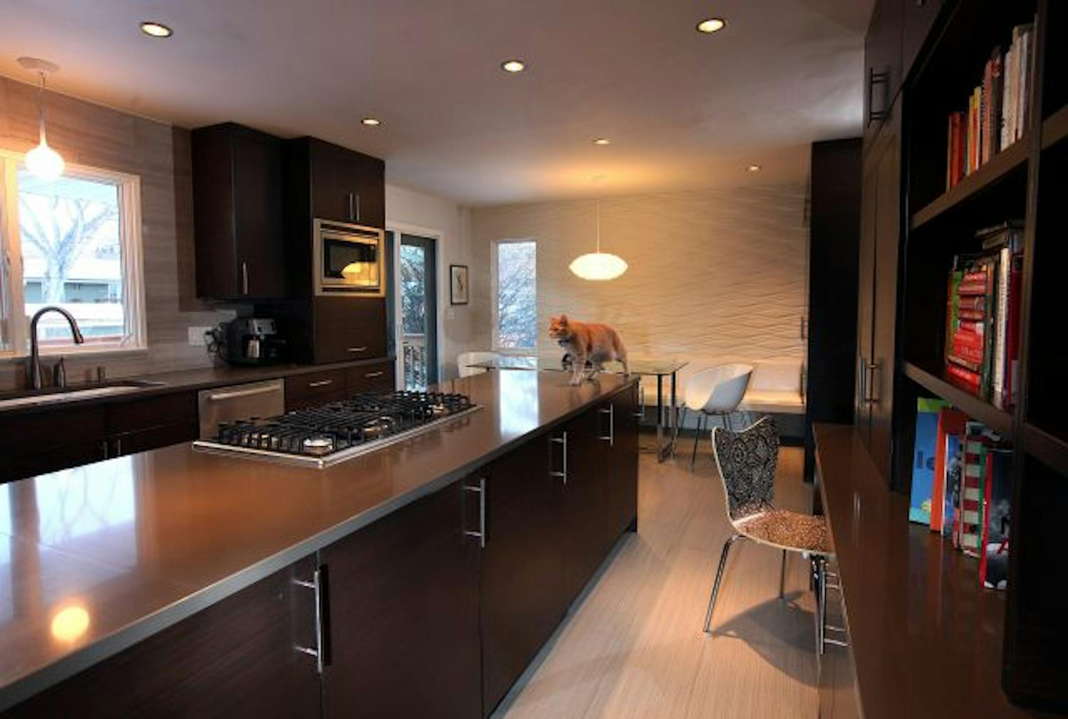 The new kitchen is sleek, modern and open; the old one was cramped and closed off from the rest of the house.