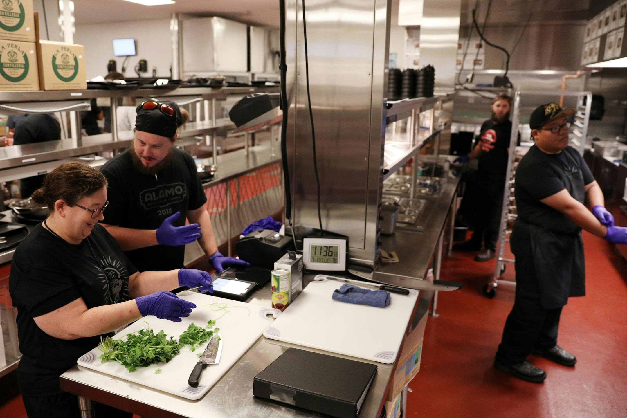 Expo corporate trainer Justin Boggs talked with Kim Johnson as she and others trained in the kitchen at Alamo Drafthouse Cinema.