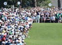 The gallery packs around the first tee watching five-time Masters champion Tiger Woods for a practice round.