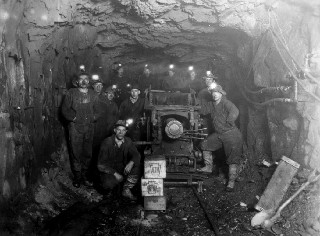 A group of miners stood next to an ore car on the Iron Range around the turn of the century. The precise location of the photo is not known.