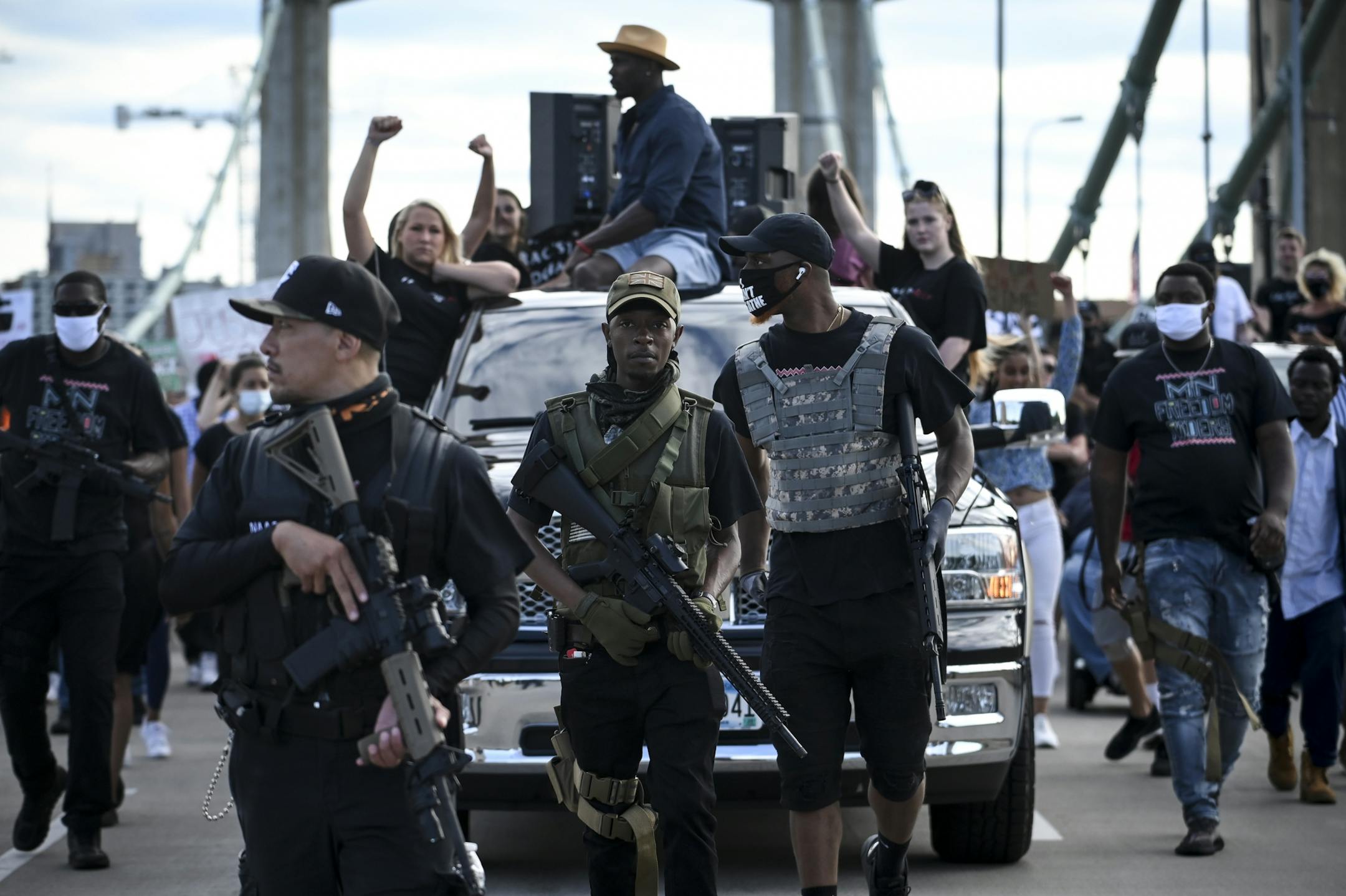 "Fox," center, a member of the Minnesota Freedom Riders, provided security while taking part in the 10k March for a Free North Saturday.