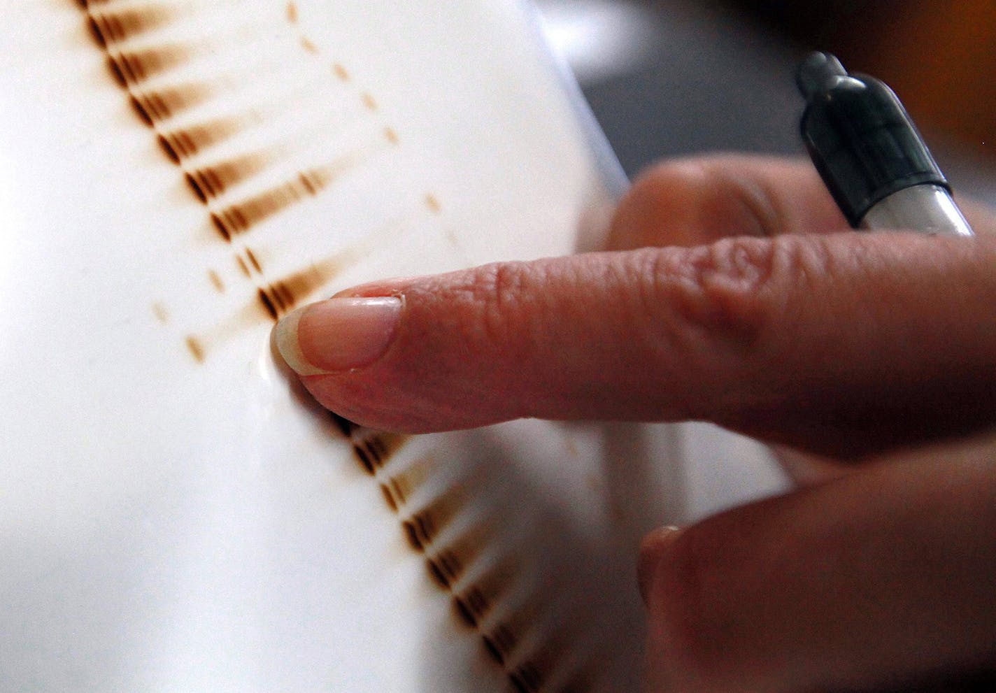 A lab technician reviews results of a newborn screen, identifying an abnormal result, as she processes screens at the Wisconsin State Lab of Hygiene at the University of Wisconsin-Madison campus, Sept. 17, 2013. (Kristyna Wentz-Graff/Milwaukee Journal Sentinel/MCT) ORG XMIT: 1145788 ORG XMIT: MIN1311202311390959