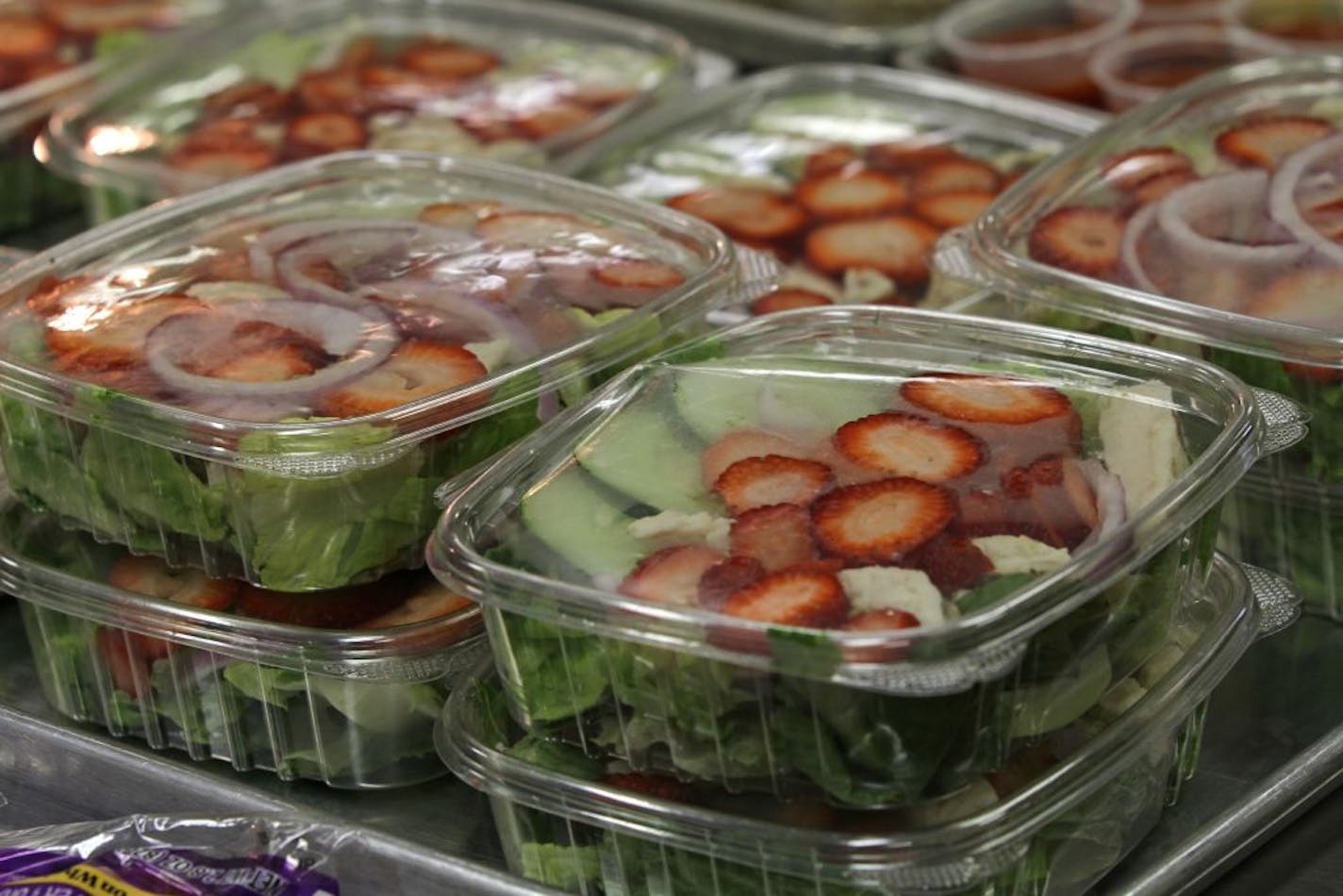 Kids at Northport Elementary School in Brooklyn Center are eating healthier foods like this salad with fruit and chicken. Last year, food service staffs were surprised when schools like Northport sold more than 500 salads a month.