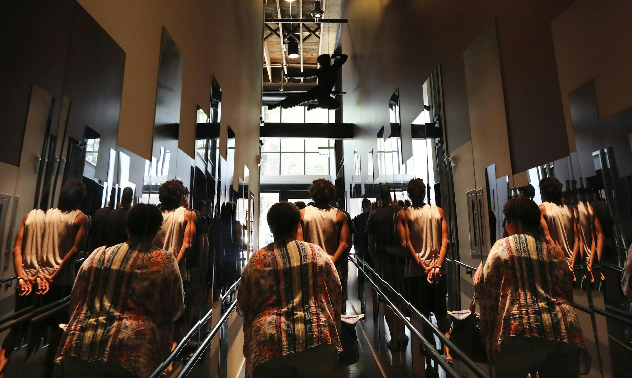 Visitors head to the self-guided tour of Bruce Lee photographs and mementos at the Wing Luke Museum. (Alan Berner/The Seattle Times/TNS)