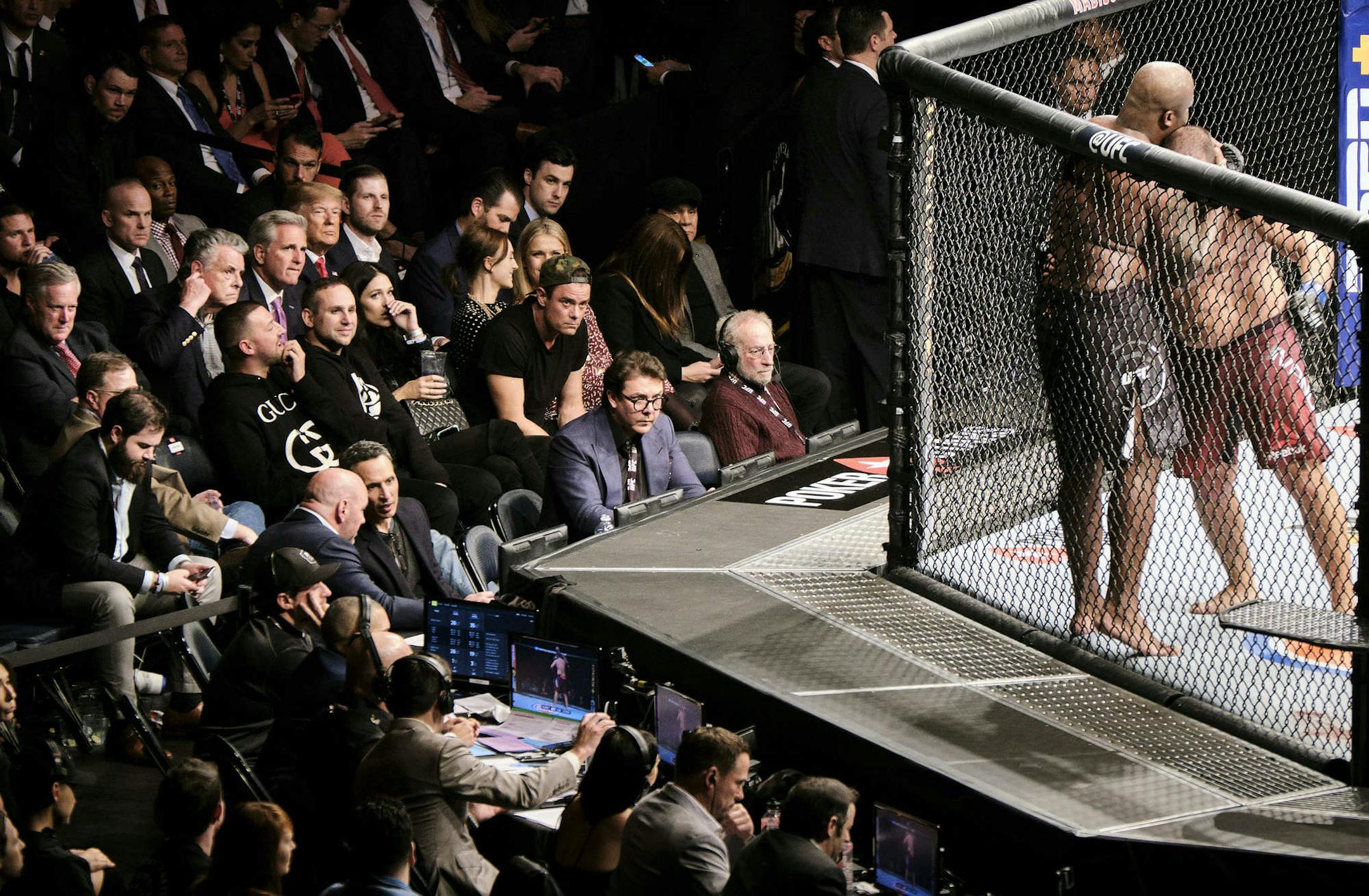 President Donald Trump, seated with Republican lawmakers and two of his sons, at the UFC 244 mixed martial arts fight at Madison Square Garden in New York, Nov. 2, 2019. Trump received a very loud, mixed reaction as he headed toward his seat next to the octagon. (T.J. Kirkpatrick/The New York Times)