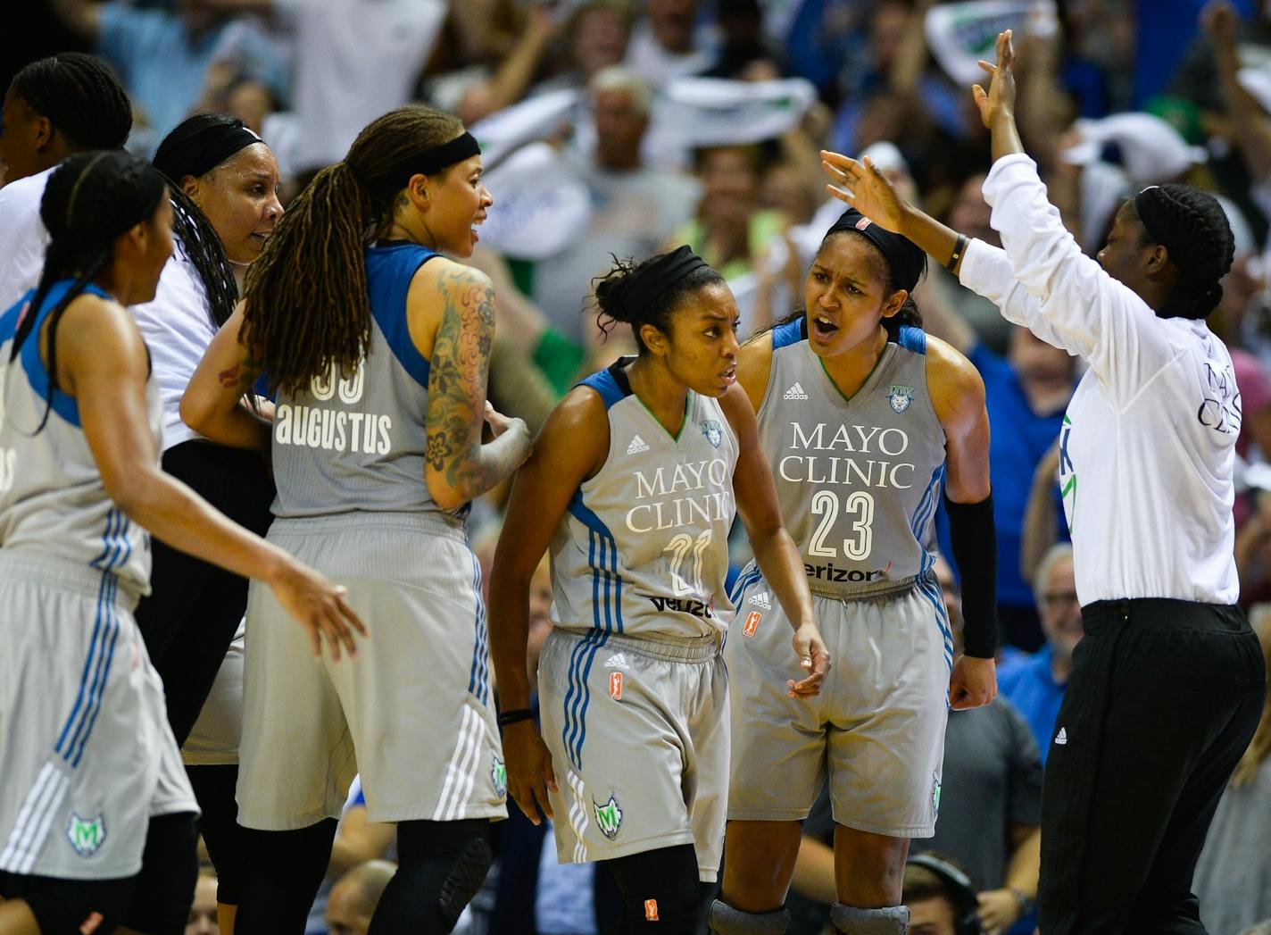 Teammates celebrated around Minnesota Lynx guard Renee Montgomery (21) after her buzzer beater to end the third quarter Tuesday night against the Washington Mystics.