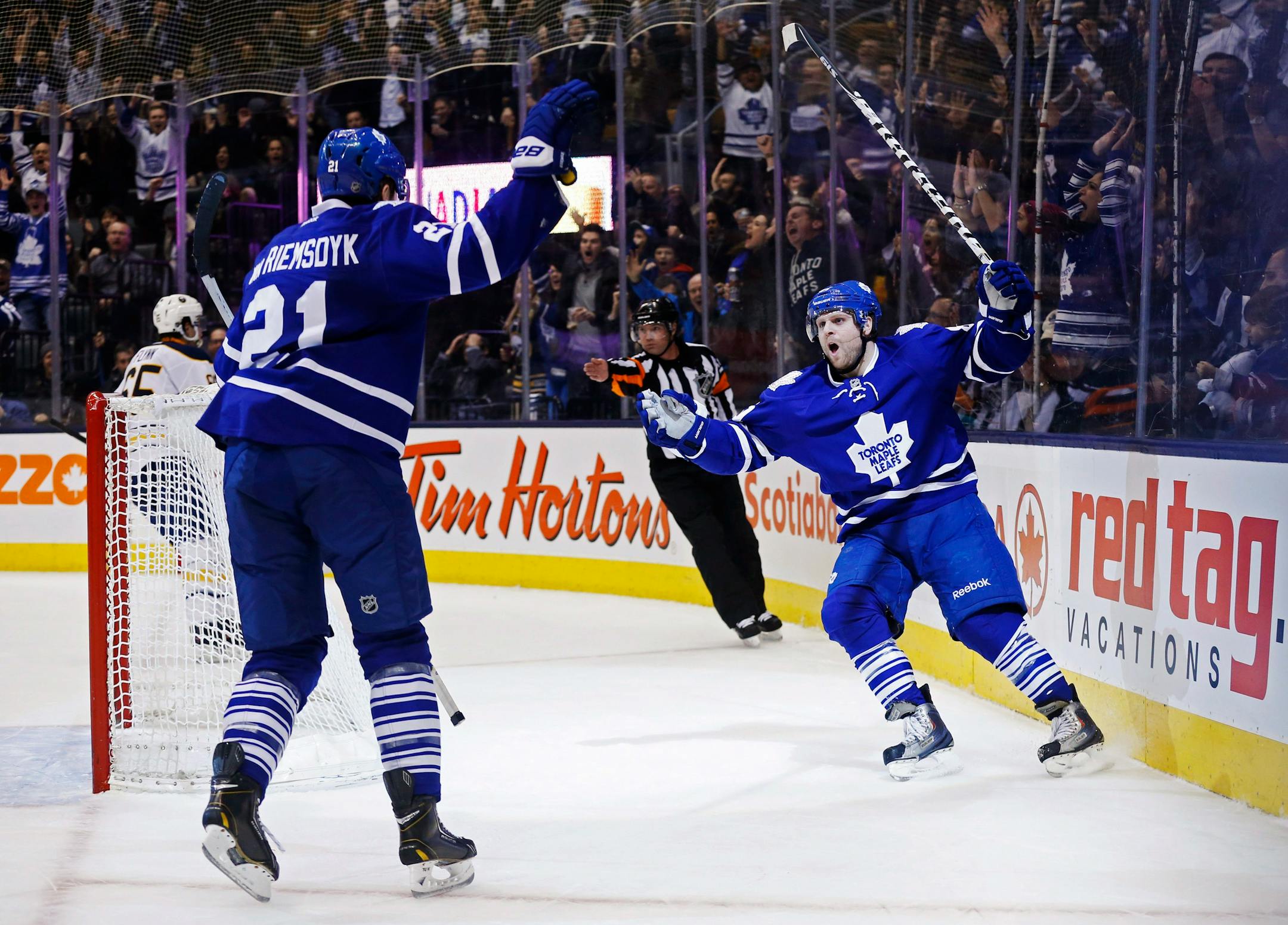 Toronto Maple Leafs' Phil Kessel, right, celebrates his goal with James van Riemsdyk during the second period of an NHL hockey game against the Buffalo Sabres on Friday, Dec. 27, 2013, in Toronto. (AP Photo/The Canadian Press, Mark Blinch)