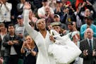 Serena Williams waves as she leaves the court after losing to France's Harmony Tan in a first round women's singles match on day two of Wimbledon
