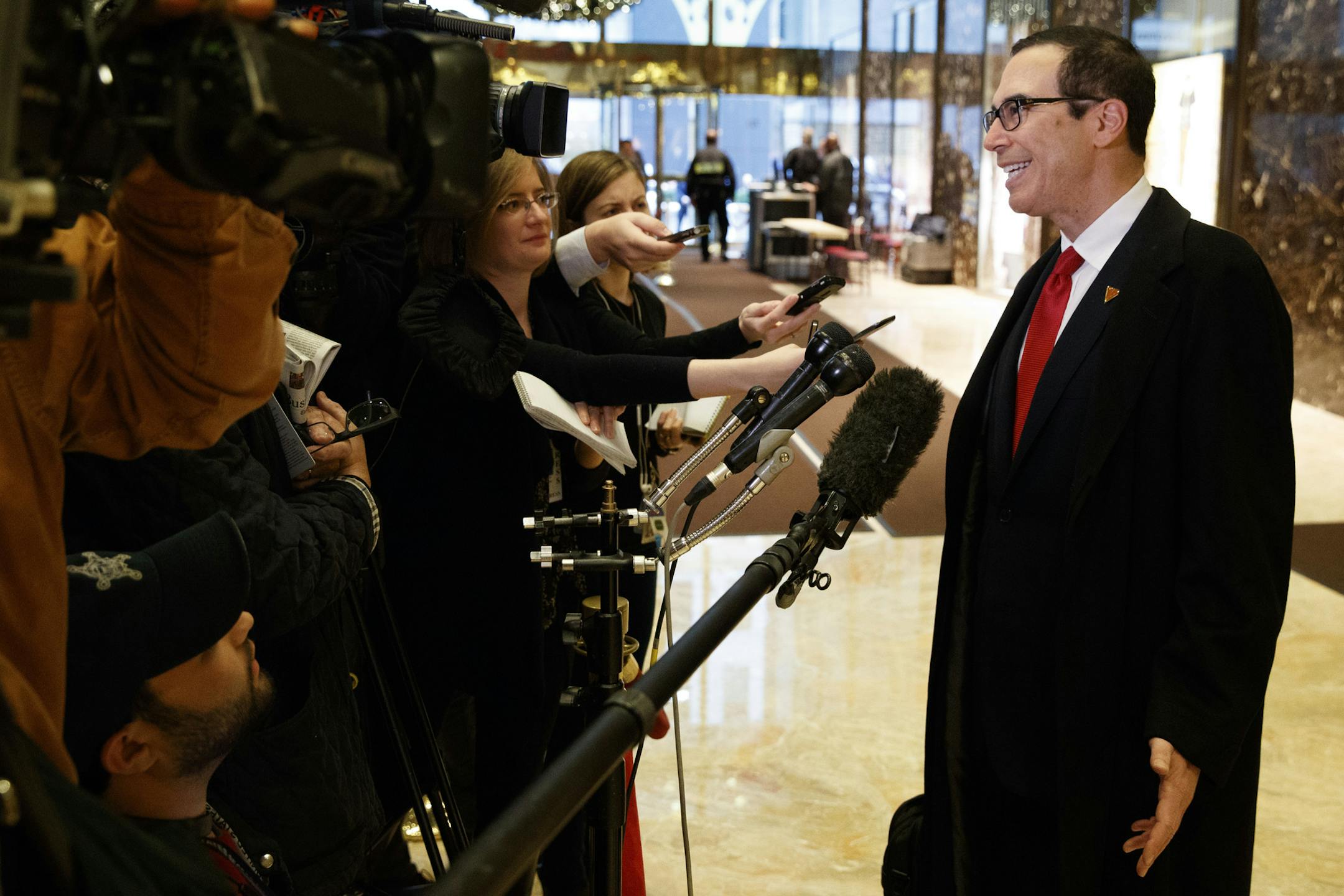 Steven Mnuchin, President-elect Donald Trump's nominee for Treasury Secretary, talks with reporters in the lobby of Trump Tower, Wednesday, Nov. 30, 2016, in New York. (AP Photo/Evan Vucci)