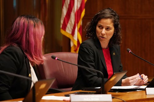 St. Paul City Council member Mitra Jalali Nelson spoke with fellow Council member Rebecca Noecker during discussion the $15 minimum wage ordnance before voting to pass it Wednesday evening.