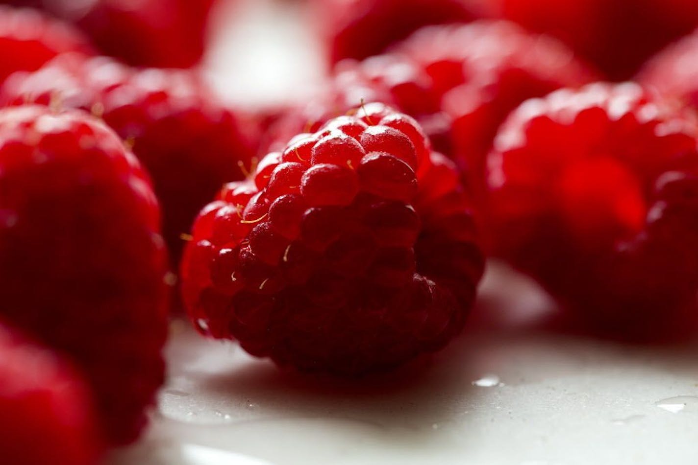 Raspberries for a tart in New York, June 2017. Green pistachio filling and tangy raspberries make a great flavor combination in this delicious tart.