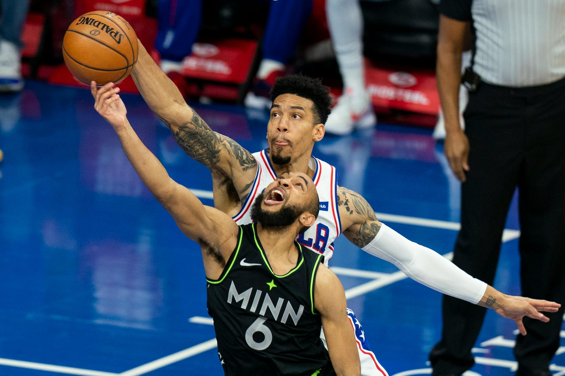 Philadelphia 76ers' Danny Green, right, blocks a shot attempt by the Timberwolves' Jordan McLaughlin, left, during the second half